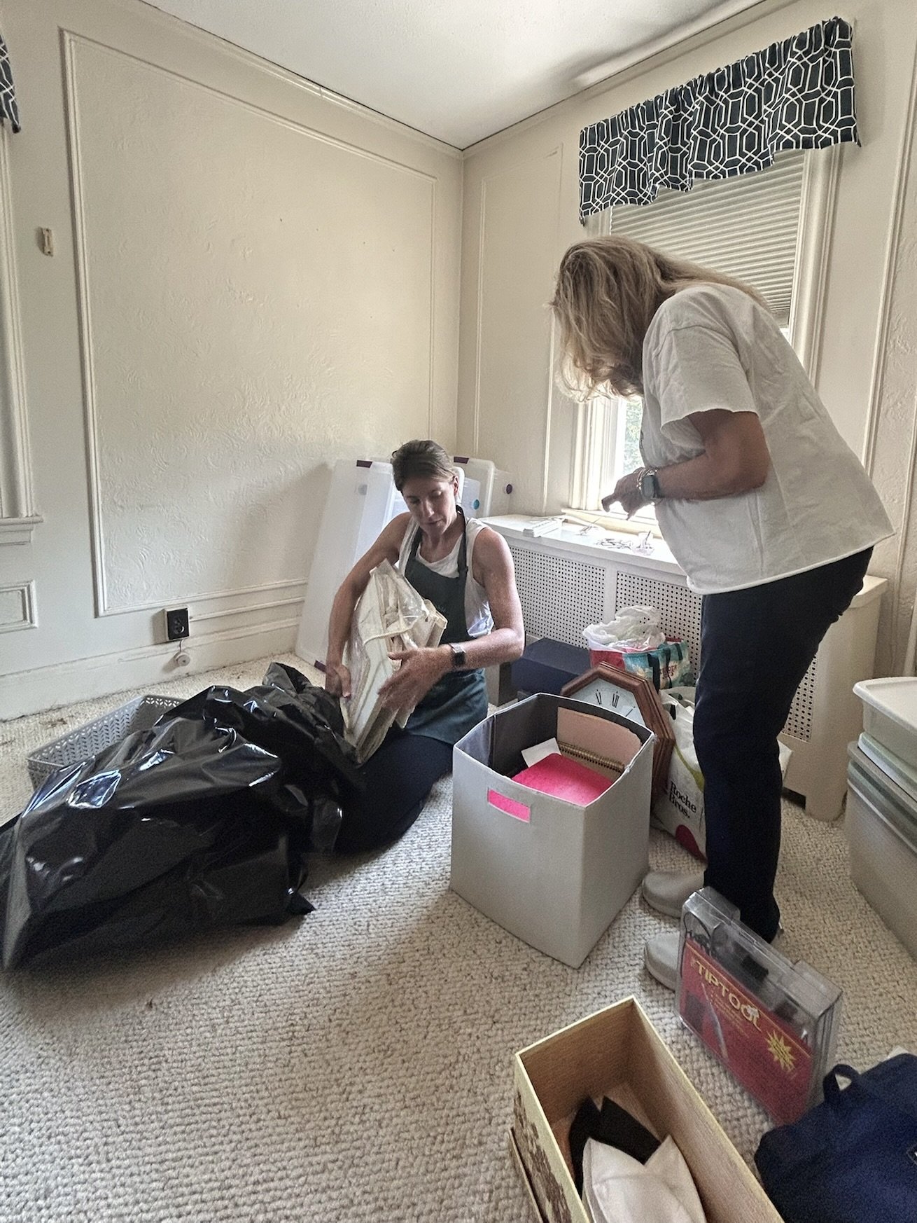 downsizable helping a senior sort through belongings