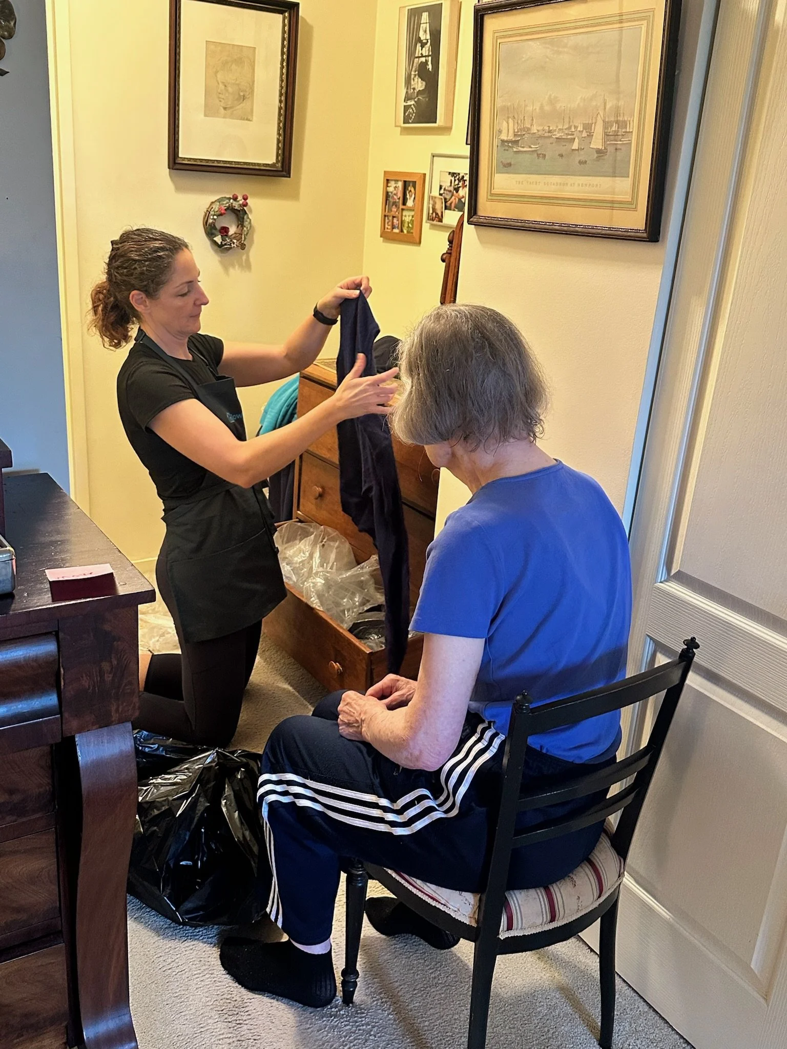 Downsizable team member helping client sort clothing during downsizing in Greater Boston