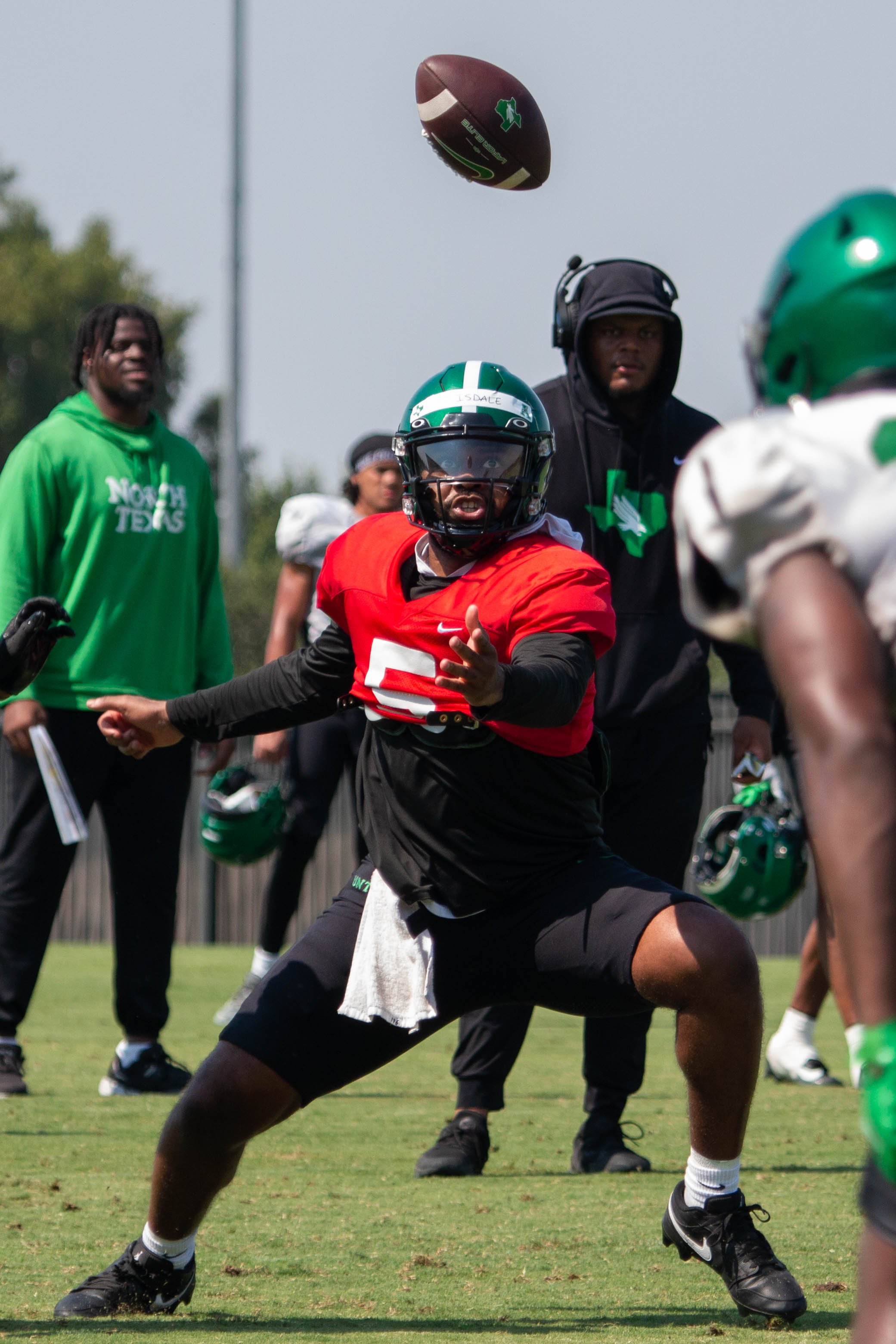 Quarterback Grant Tisdale fumbles the snap in a practice on August 8, 2024