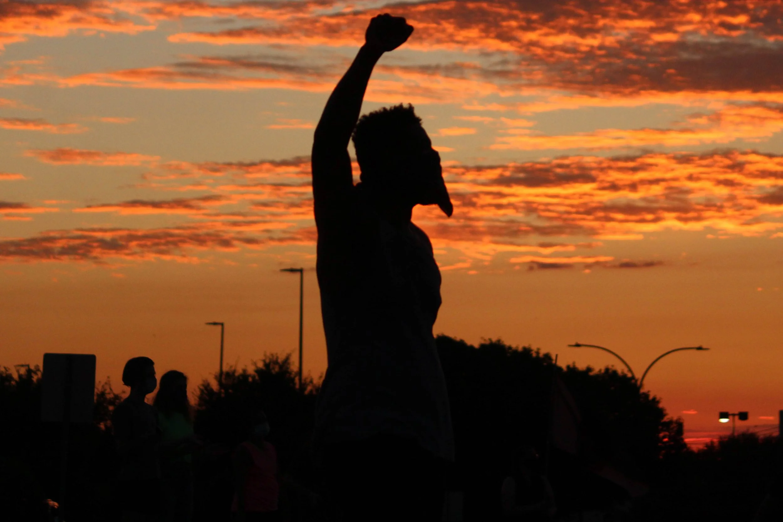 A protester raises his arm in Arlington on July 29, 2020