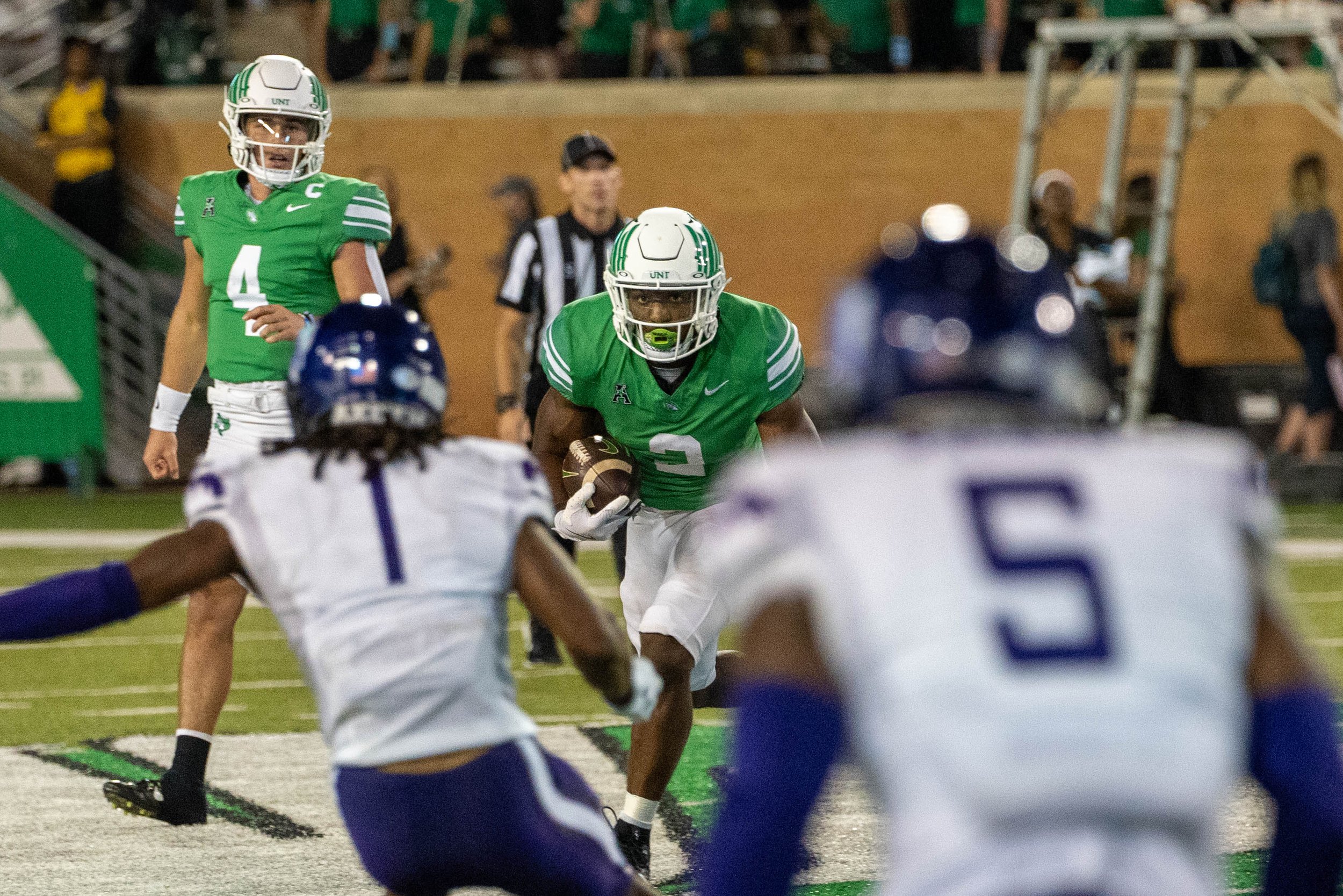 Running Back Juwan Price runs at two defenders in a game against ACU on Sept. 7