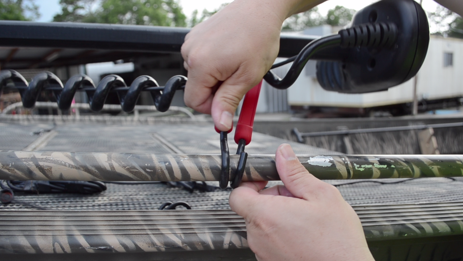 Red bungee strapping cargo to a boat