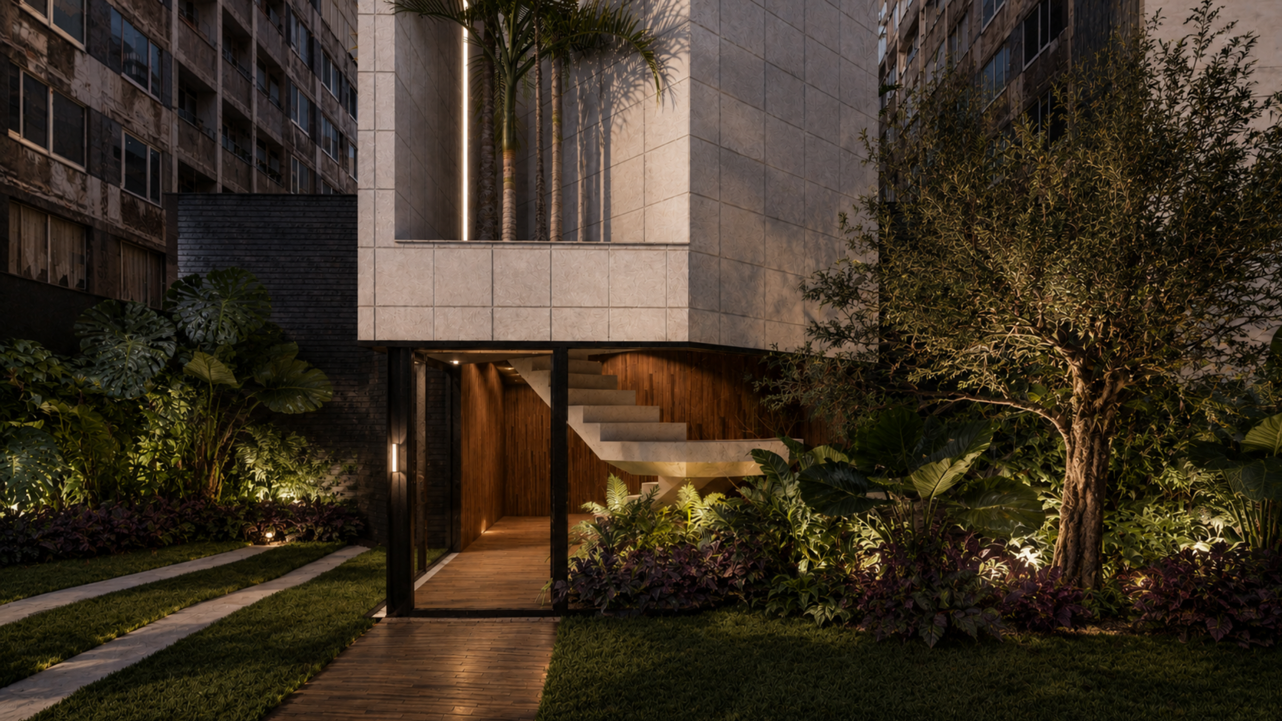 Jardim de entrada em predio no anchieta com caminho de madeira, gramado, árvores, plantas grandes e uma entrada de vidro com escada interna, ao entardecer ou noite, feito pela construtora abreu