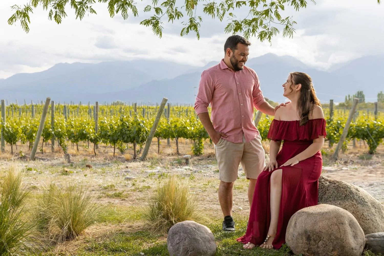 Couple together in a vineyard on a wine country honeymoon