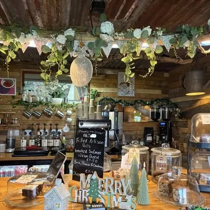 Decorated wooden cafe counter with Christmas and seasonal decorations, including a white 