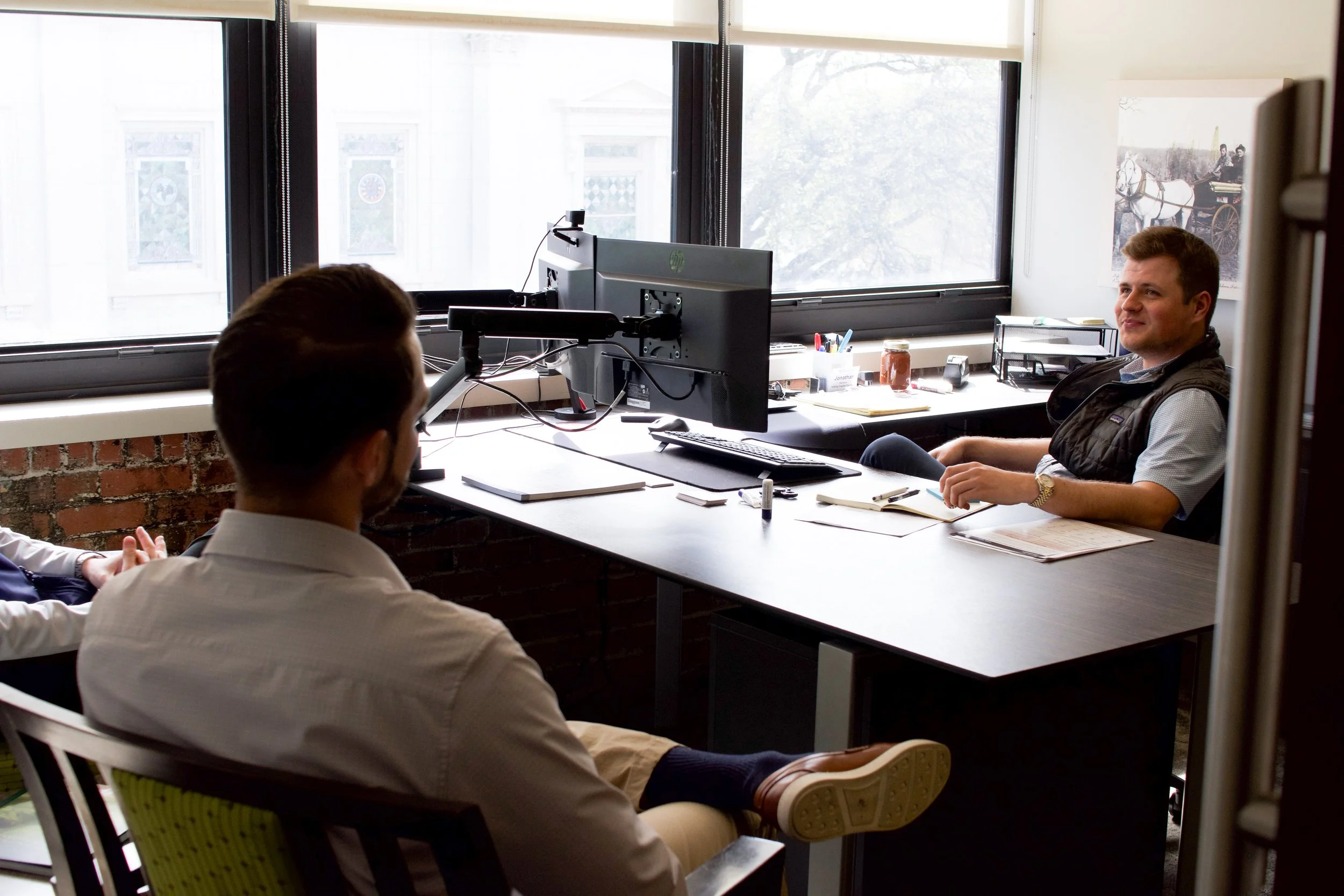 Two men sitting in an office at a desk