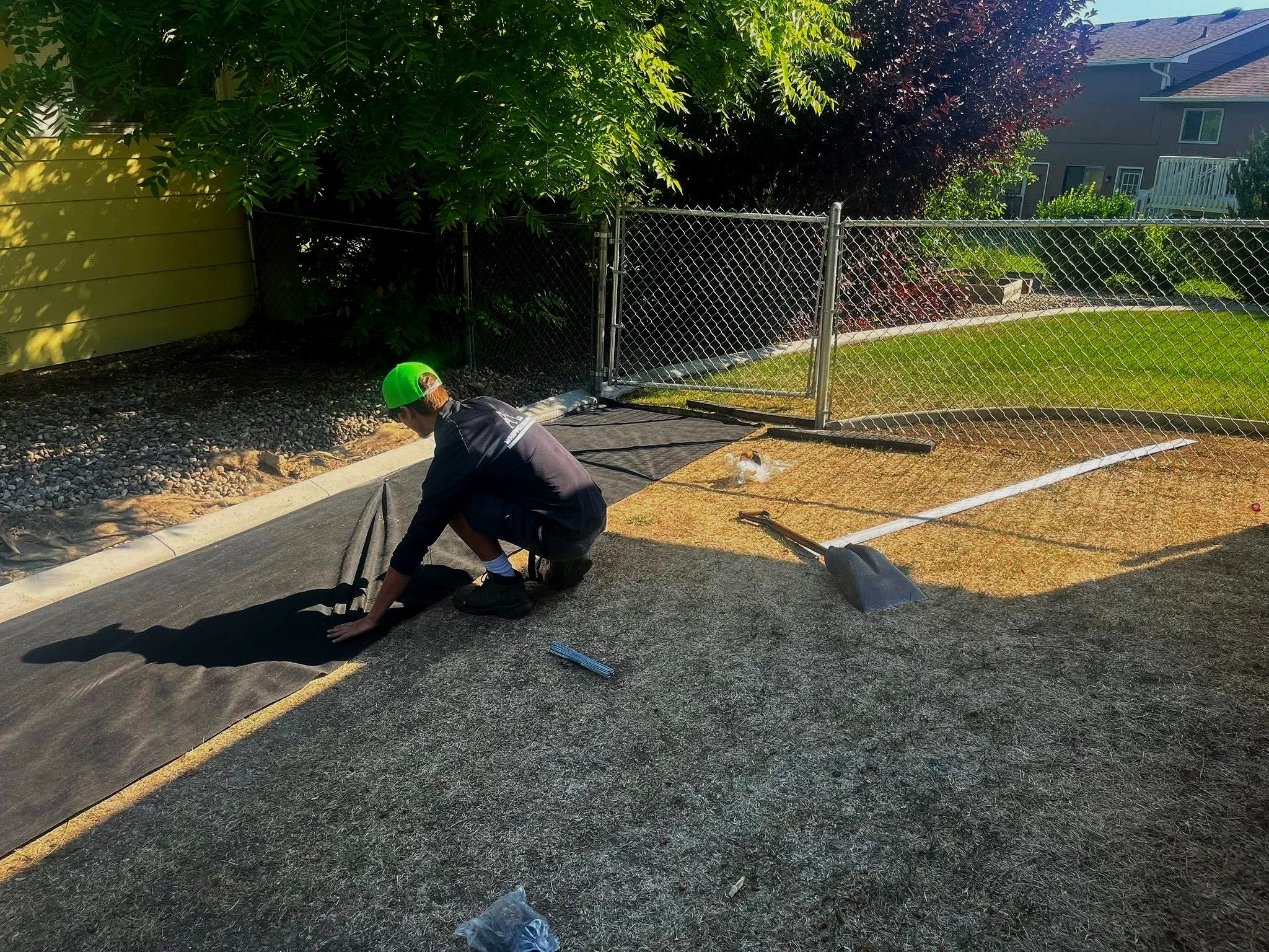 Landscape fabric installation and bed preparation completed by Whipper Snapper Lawn Care to prevent weeds and improve landscape longevity