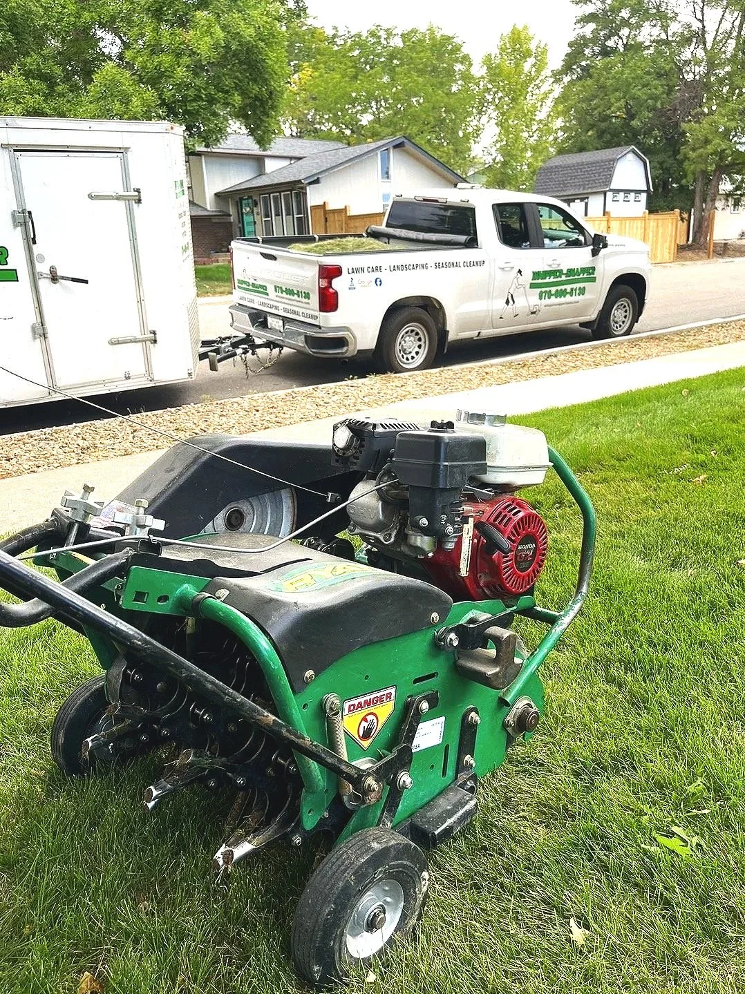 Professional lawn aeration and turf maintenance equipment used by Whipper Snapper Lawn Care on a residential property