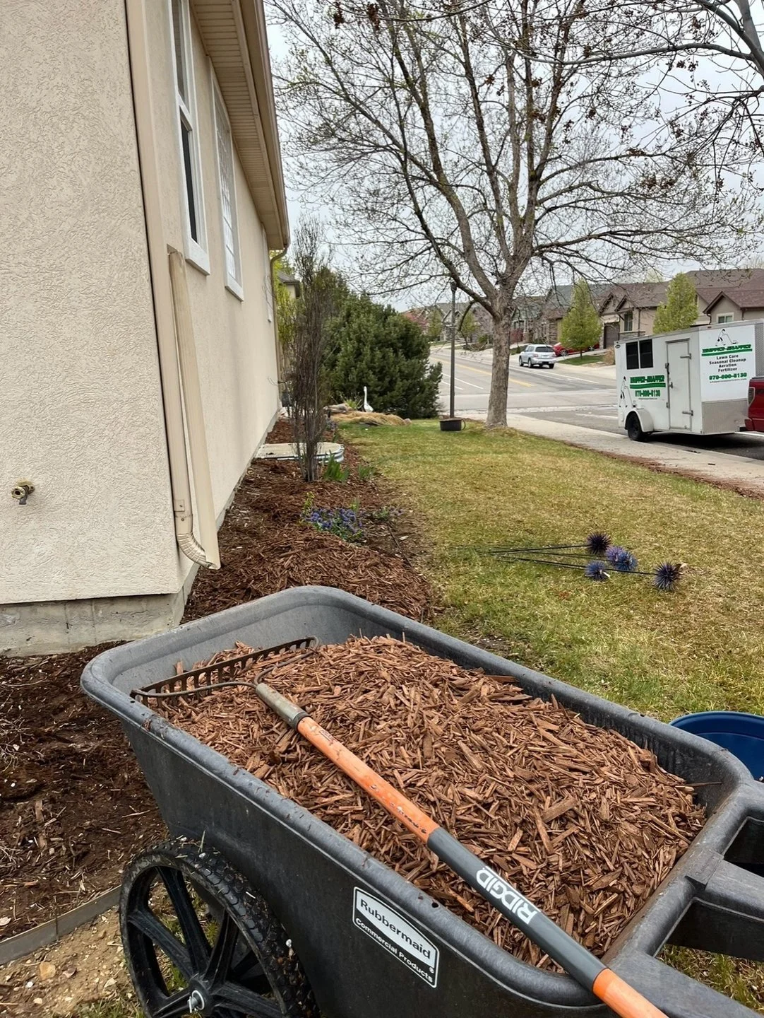 Mulch installation and landscape bed maintenance completed by Whipper Snapper Lawn Care at a residential property