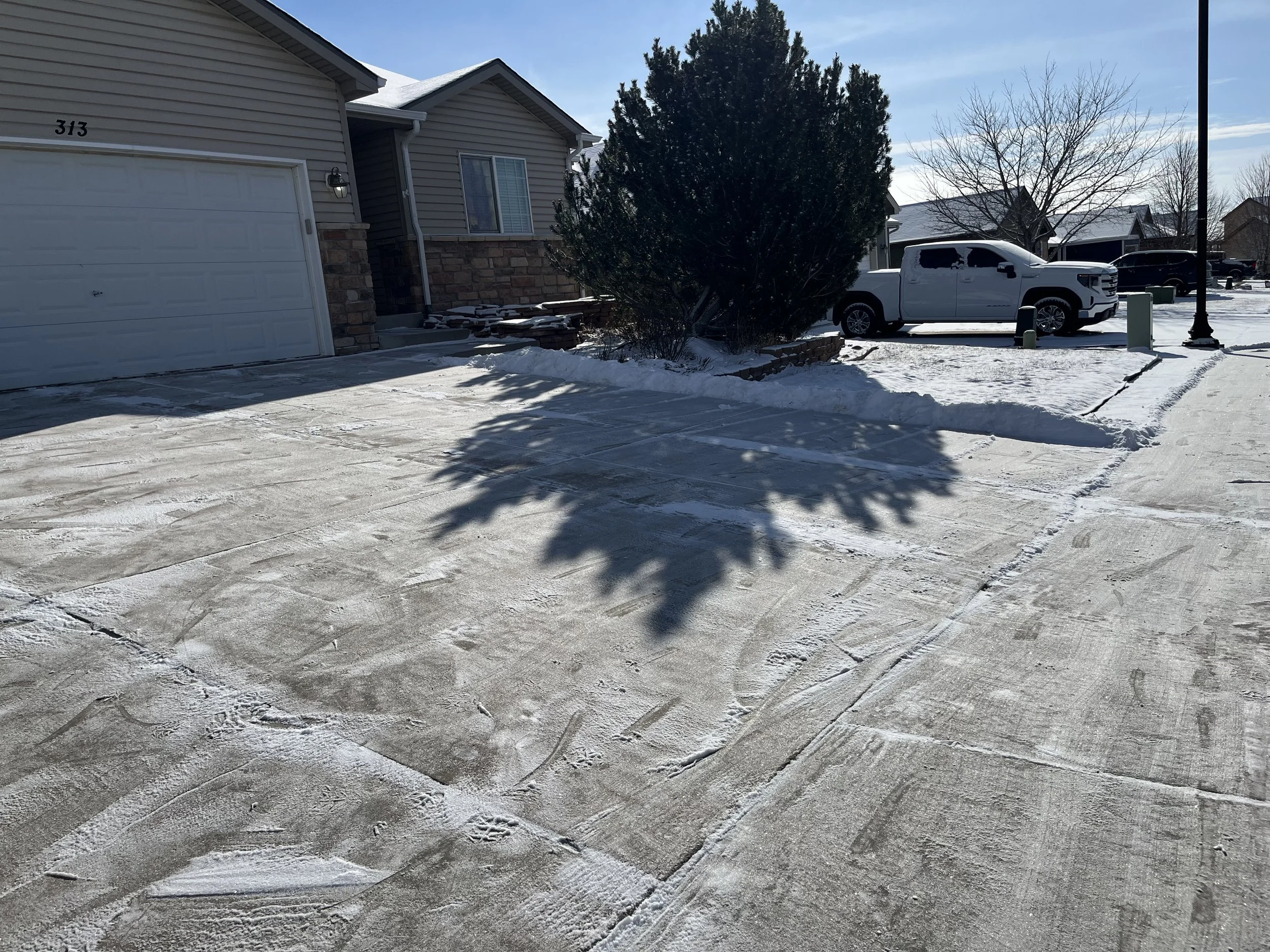 Whipper Snapper Lawn Care freshly cleared residential driveway after professional snow removal service
