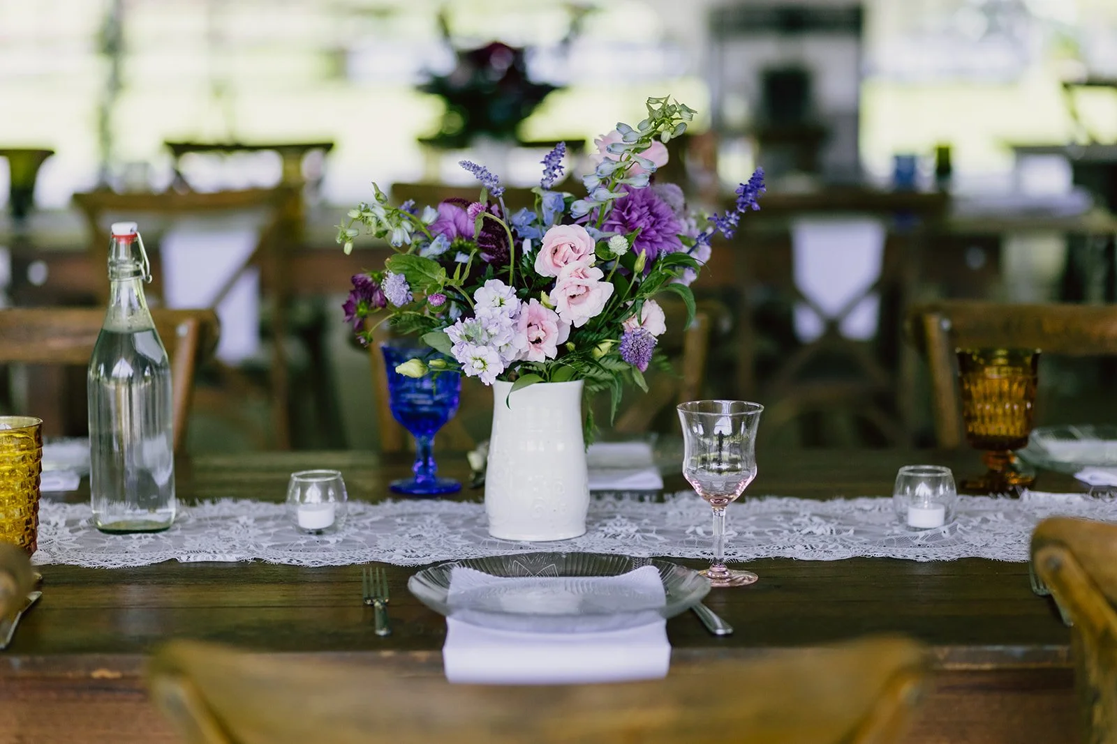 Romantic Asheville wedding reception floral centerpiece with blush and purple bloom
