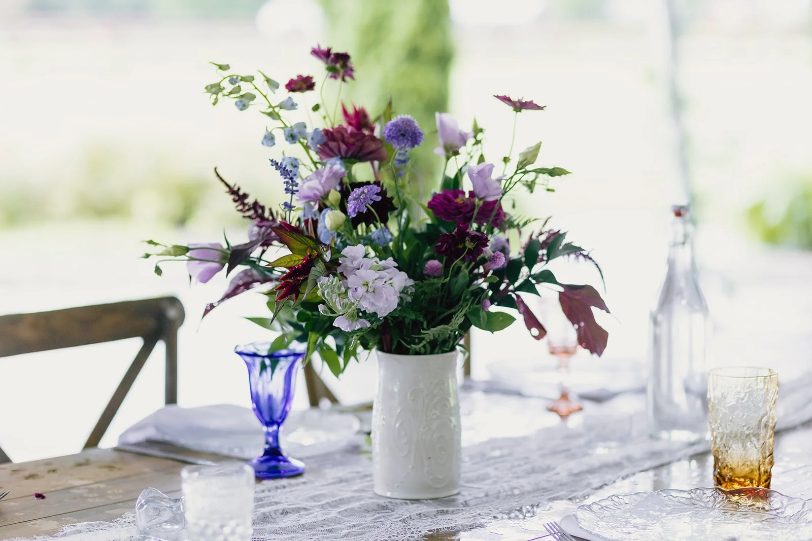 Romantic Asheville wedding reception floral centerpiece with purple