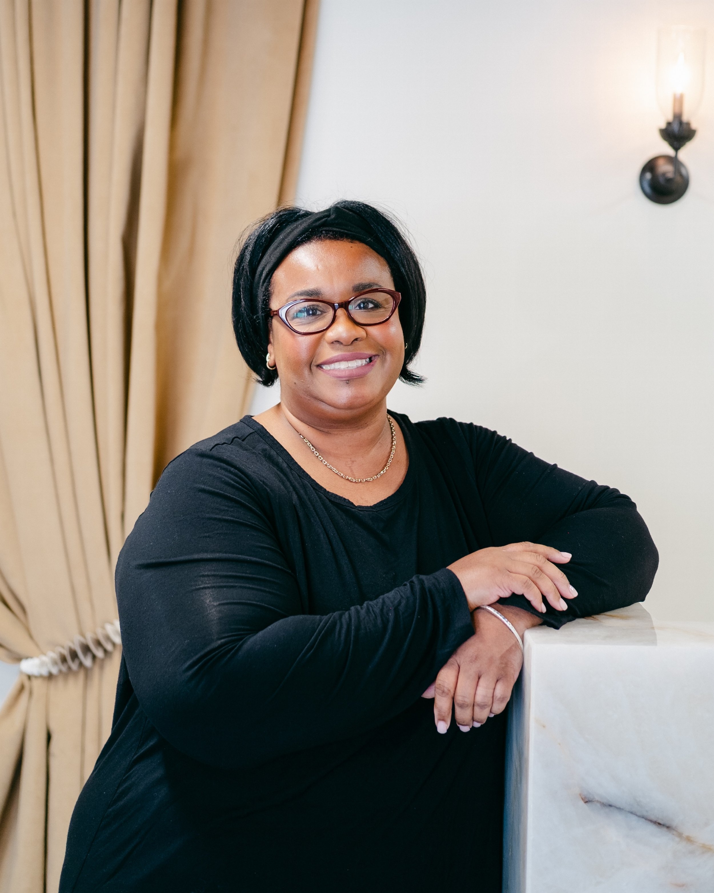 Portrait of Dee Harrell, nail technician at Opal Salon specializing in gel manicures, acrylic nails, pedicures and classic nail services in Tuscaloosa, Alabama.