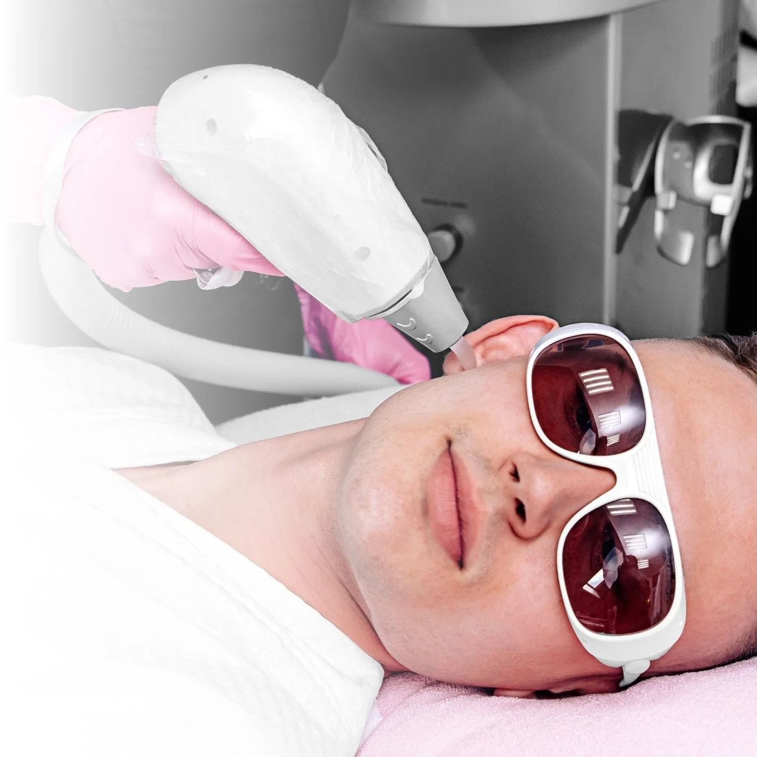 Person receiving a laser treatment on face while wearing protective goggles.