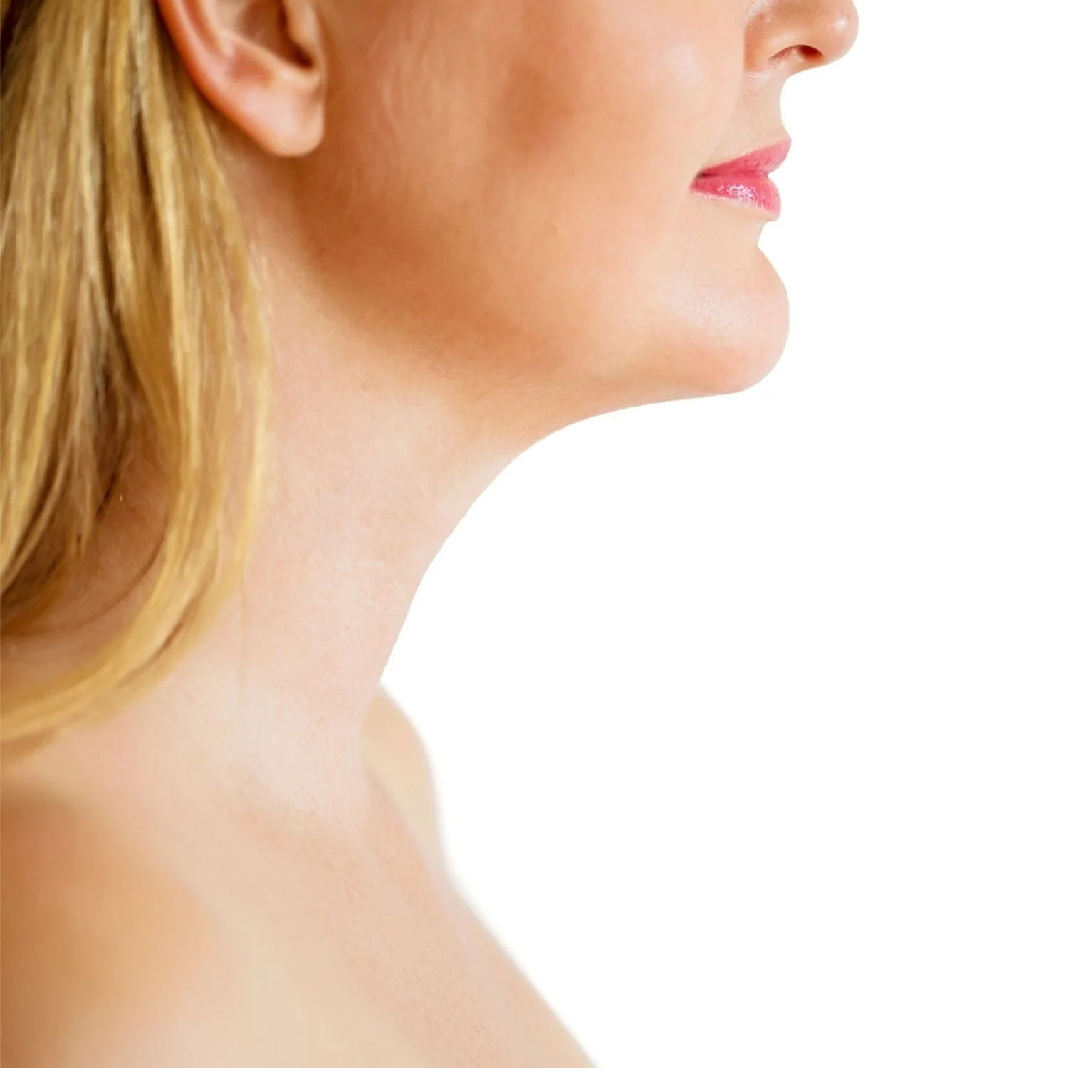 Profile view of woman's chin and neck on white background