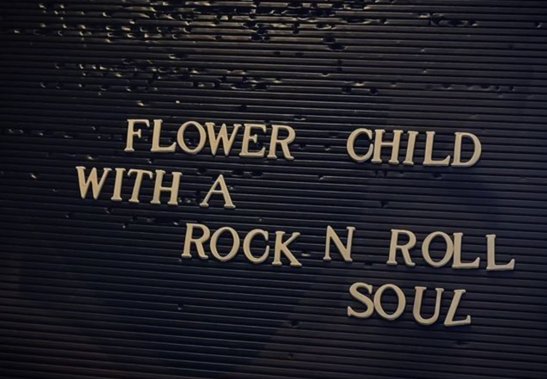 Letter board with the phrase "Flower Child with a Rock n Roll Soul."