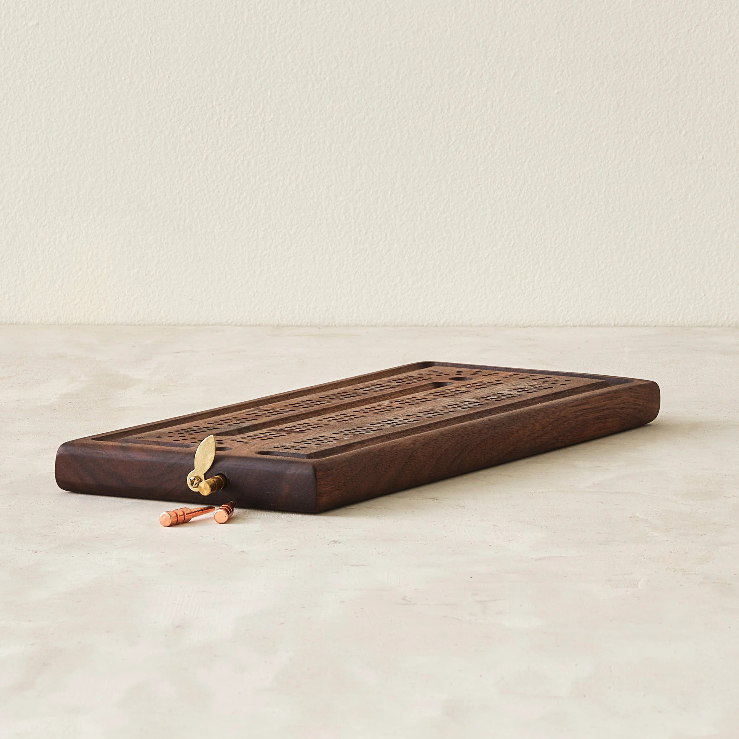 modern three-track cribbage board with pegs and storage in walnut or cherry