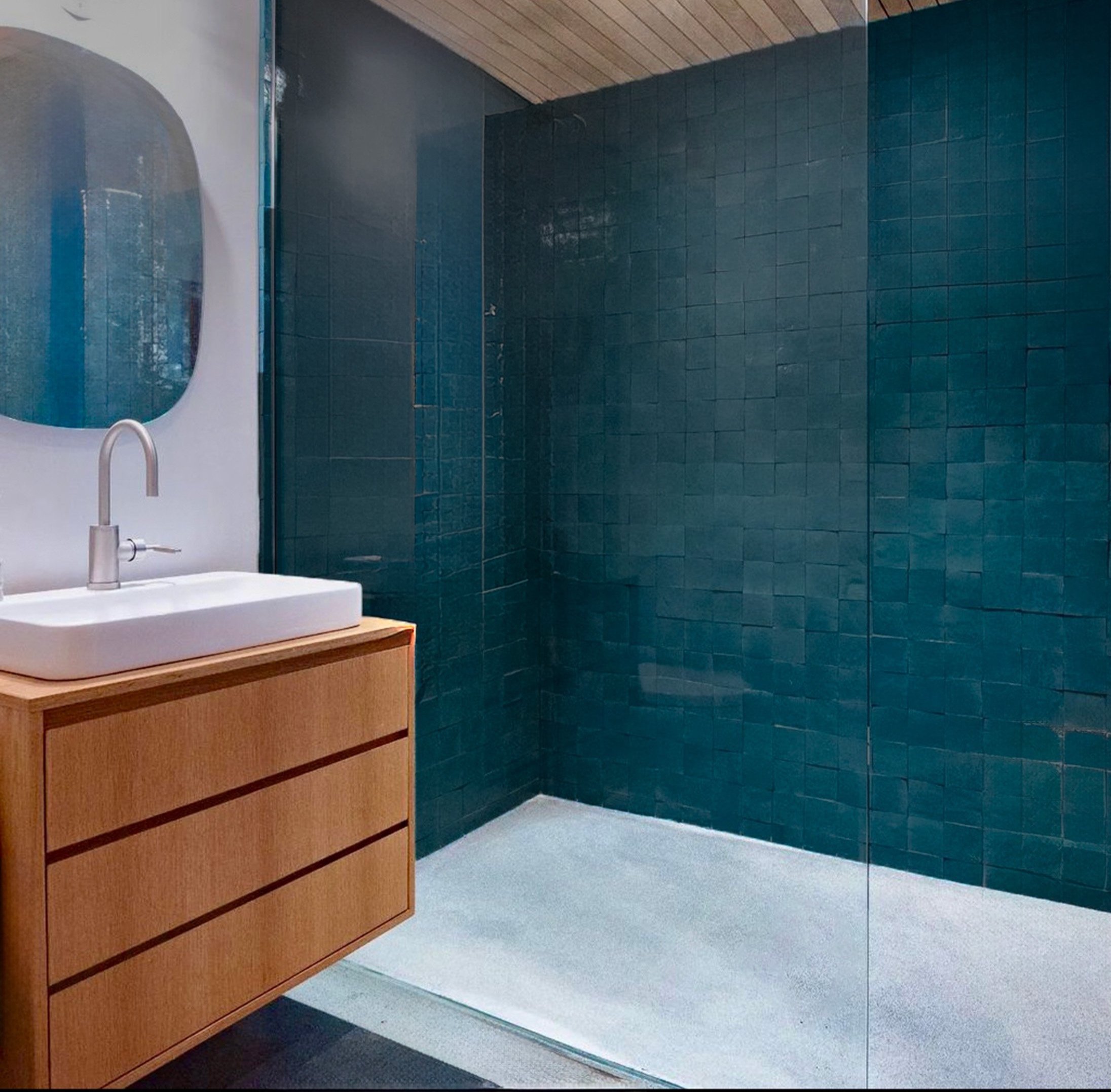 modern wood vanity in white oak with blue tiled shower
