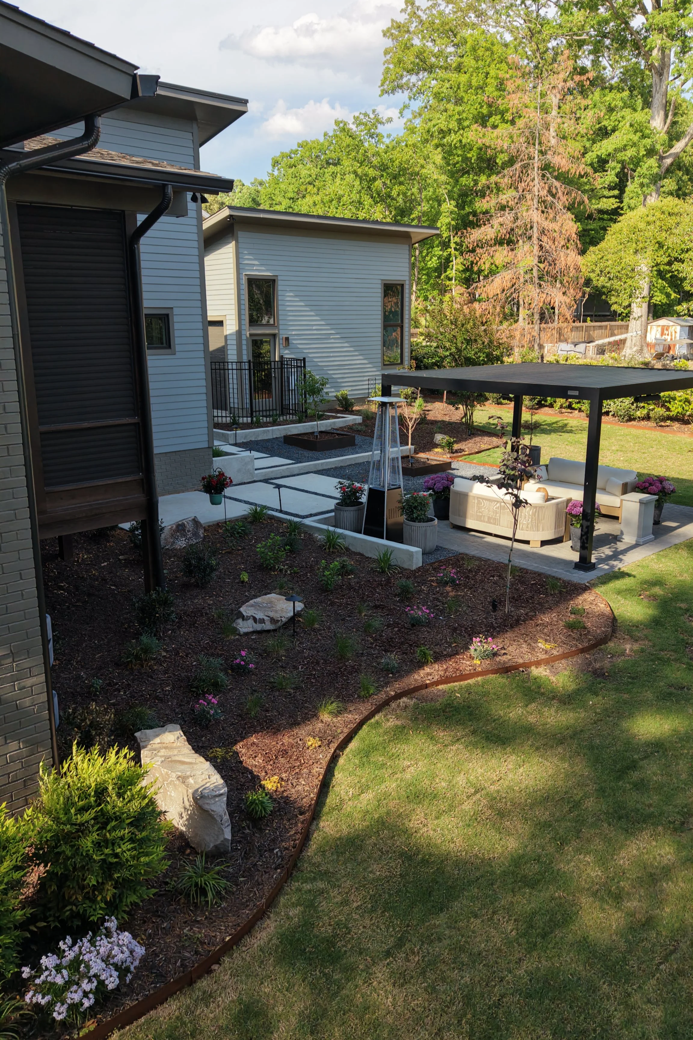 Outdoor living space with louvered pergola and landscape in Downtown Cary, NC