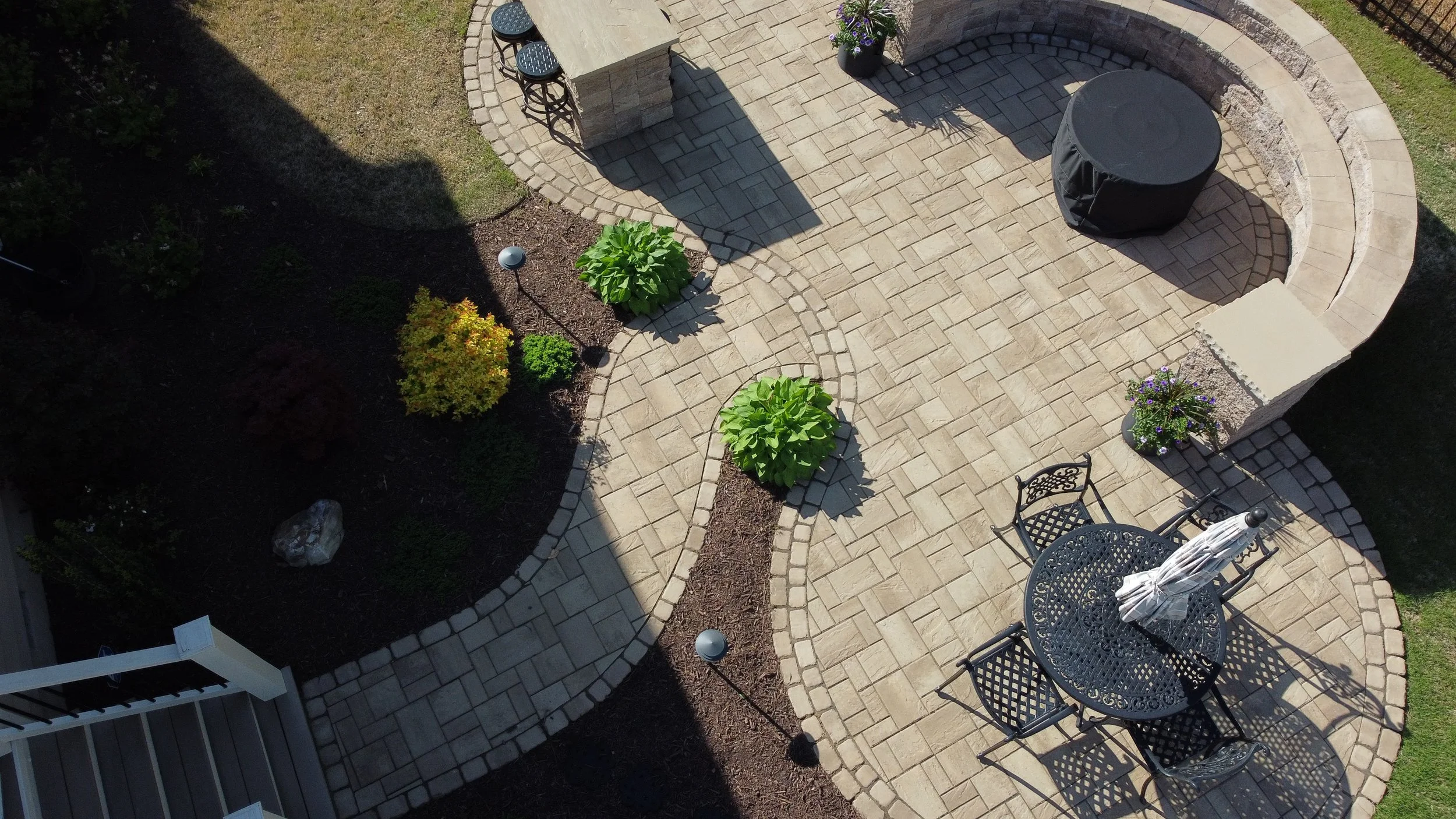 Outdoor stone patio with seating walls and dining island in Cary, NC