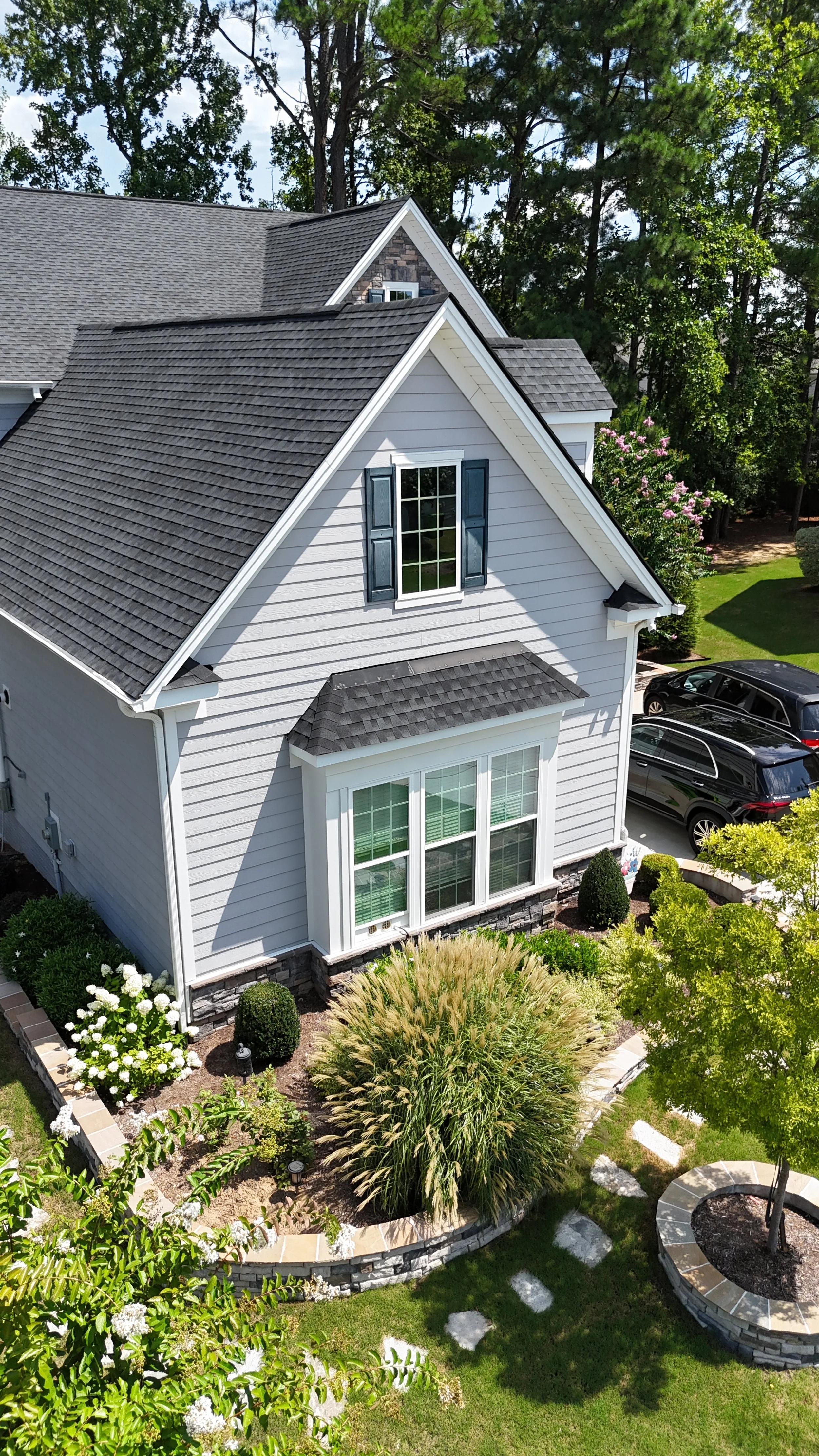 Farmhouse stone wall, landscaping design, and stepping stones in Raleigh, NC