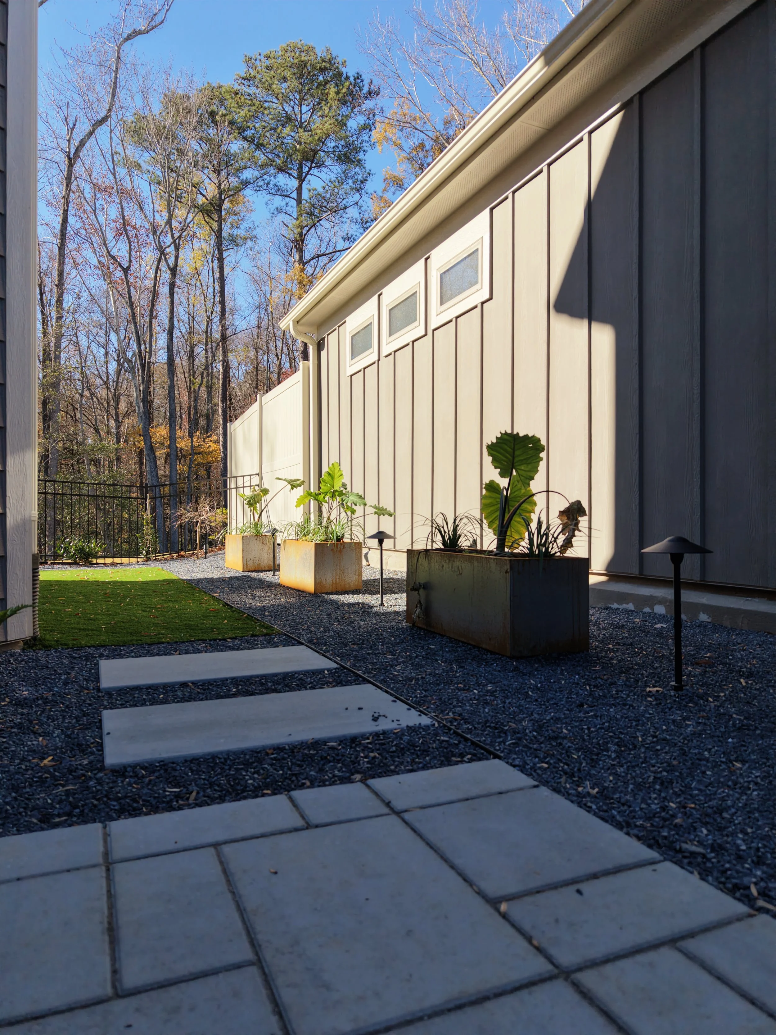 Modern paver patio with decorative gravel and steel planters in Raleigh, NC