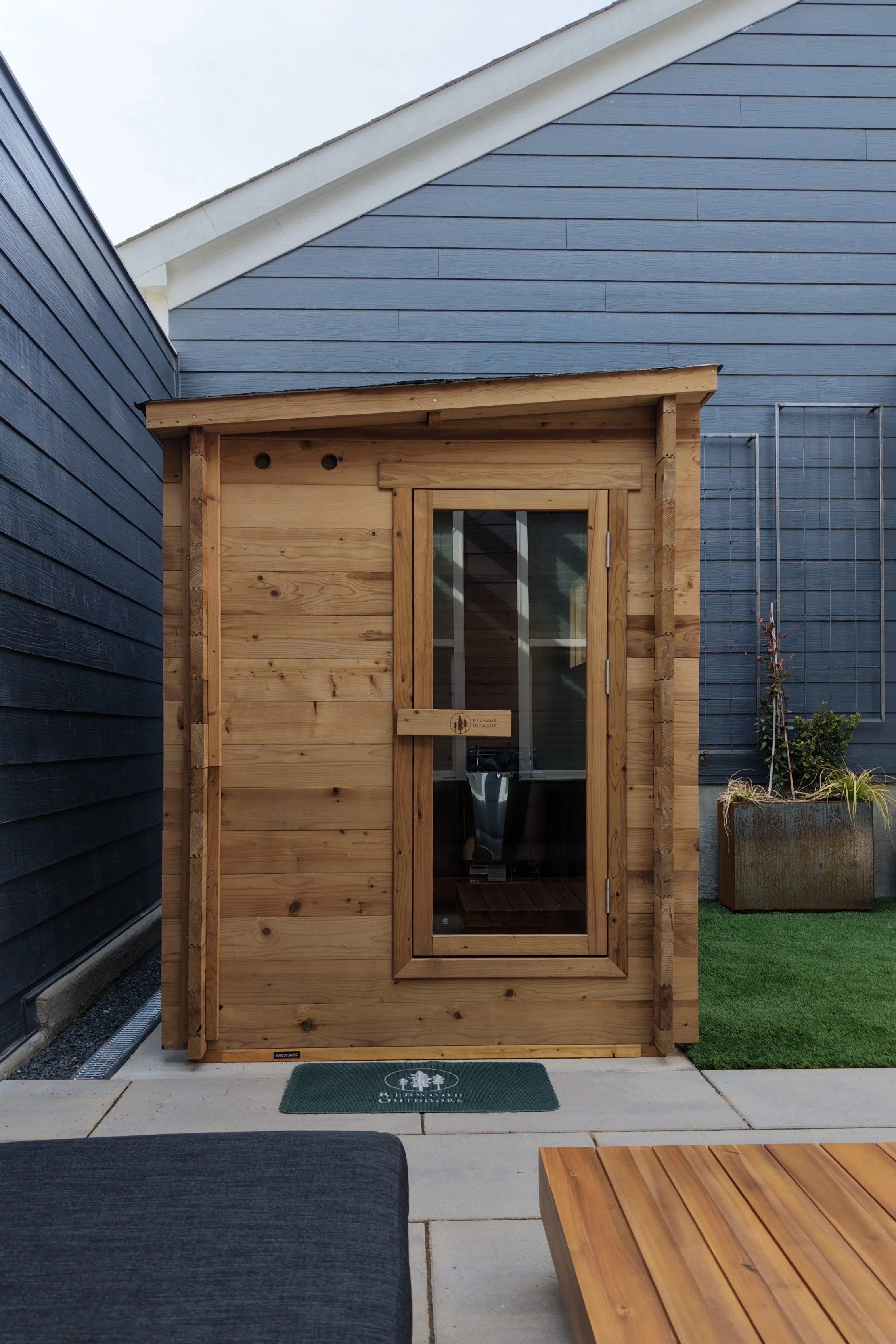 Paver patio with sauna and landscape features in Apex, NC