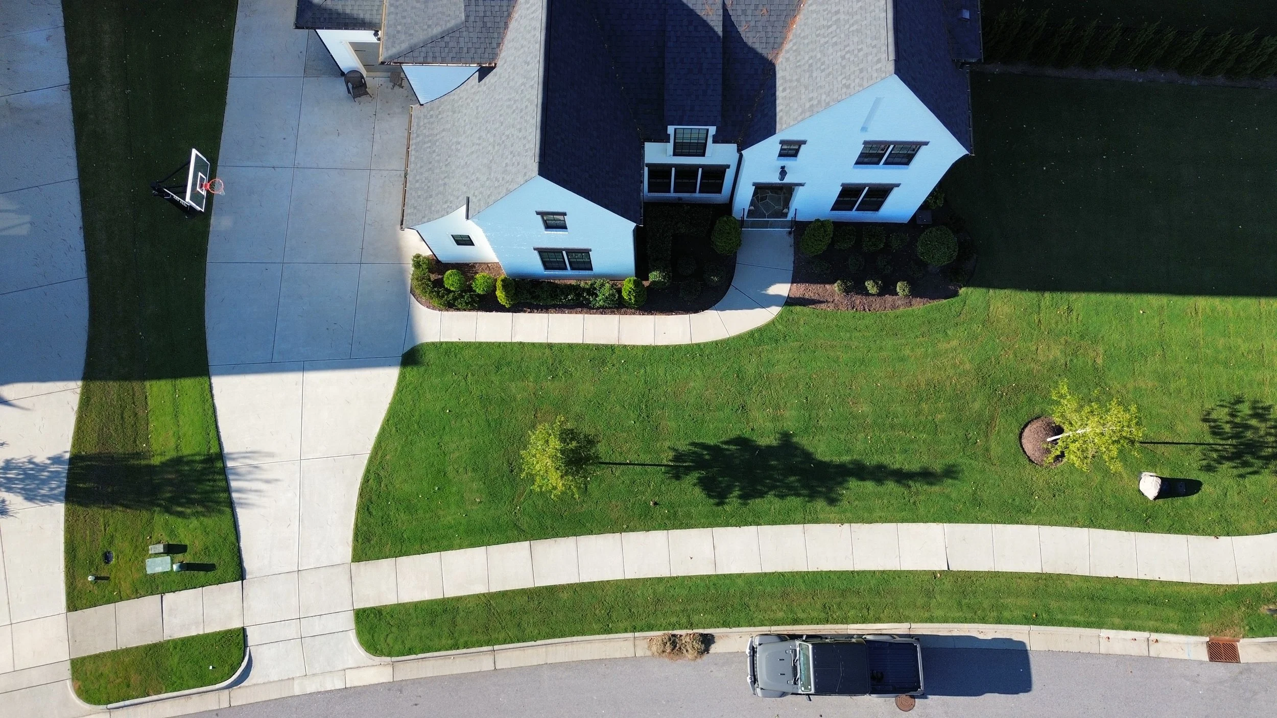 Aerial view of residential property with professionally maintained landscaping by residential landscape maintenance services in Cary, NC