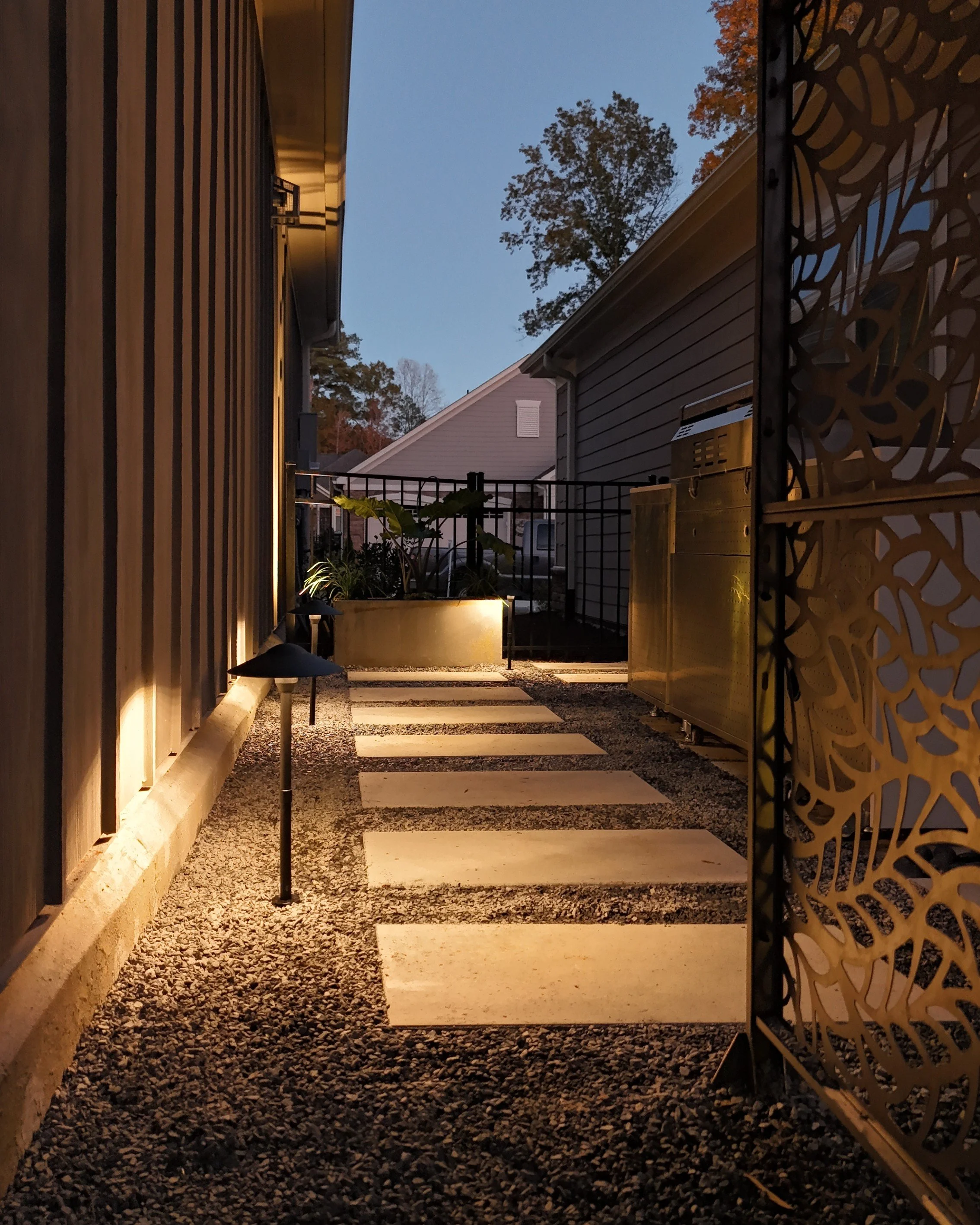 Stepping stones embedded in decorative gravel with lighting in Raleigh, NC