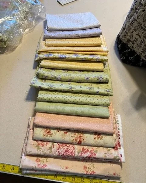 Fabrics sourced for the additional pinwheels to be added to enlarge the quilt.  Many different quilt shops were visited to find the appropriate fabrics for this project