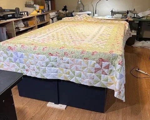 The new pinwheels have all been added.  Now the quilt is ready for the new border and the additional backing to be added