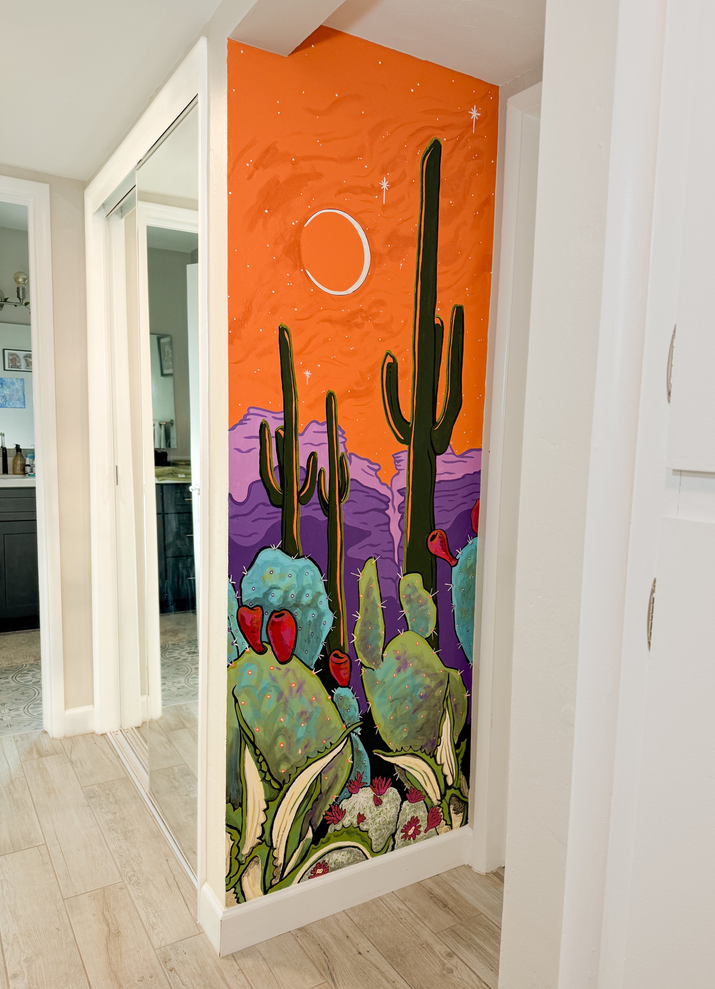 An interior mural at a private residence in Tucson, Arizona featuring colorful cacti and a dreamy background.