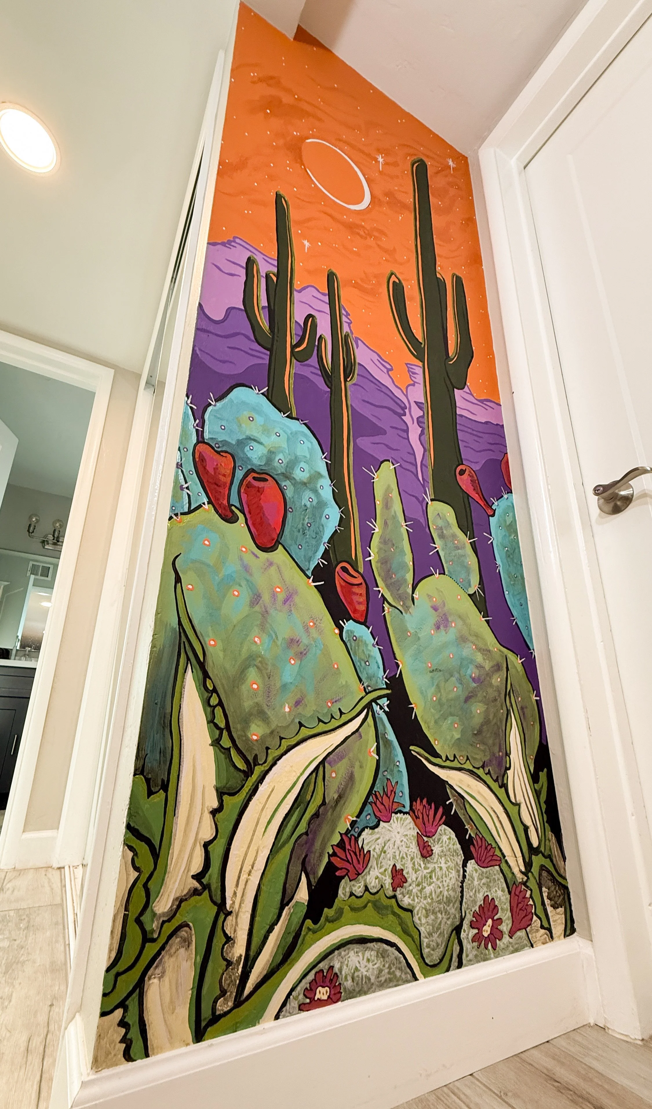 An interior mural at a private residence in Tucson, Arizona featuring colorful cacti and a dreamy background.
