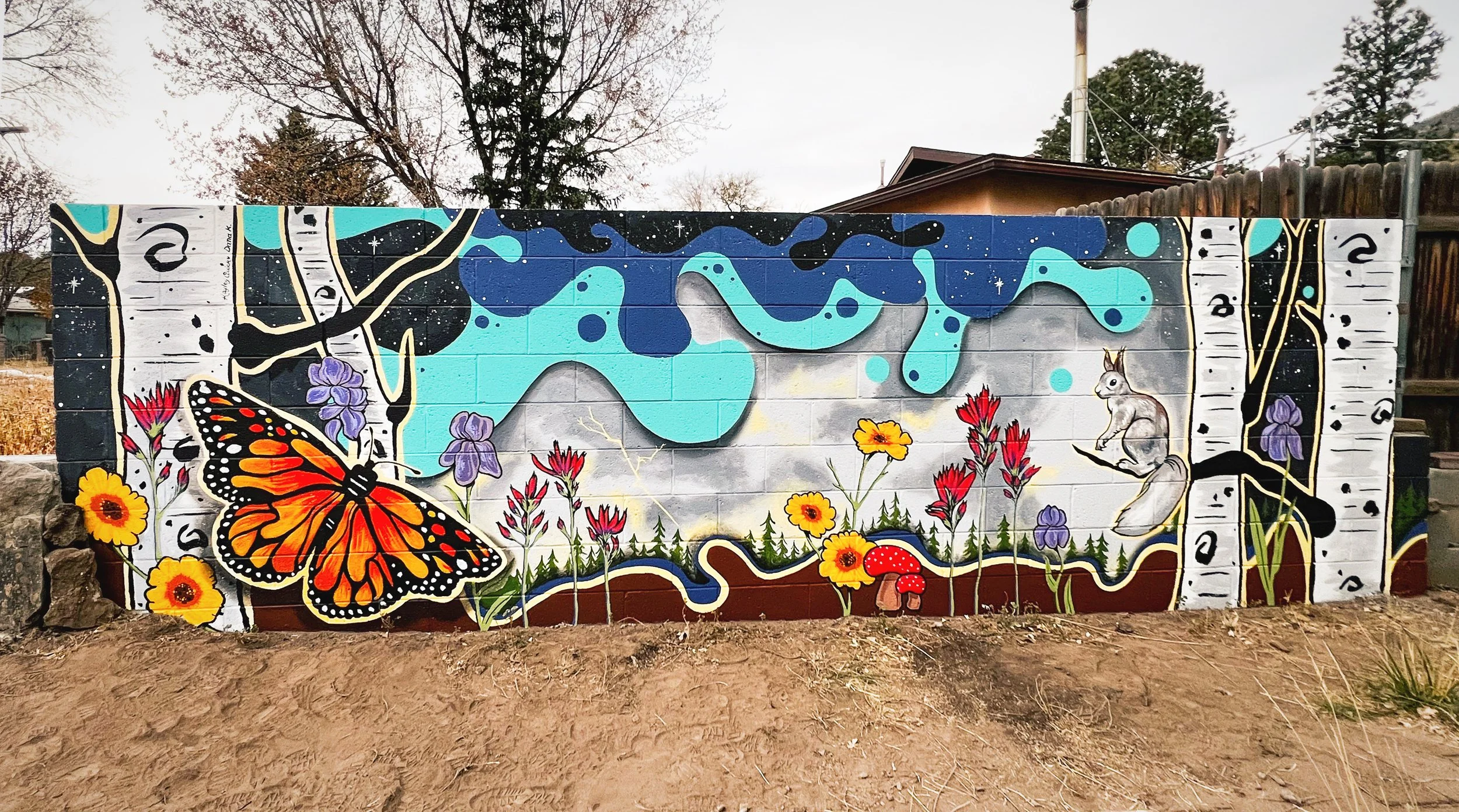 An exterior wall mural at a private residence in Flagstaff, AZ that is used to mitigate flooding.