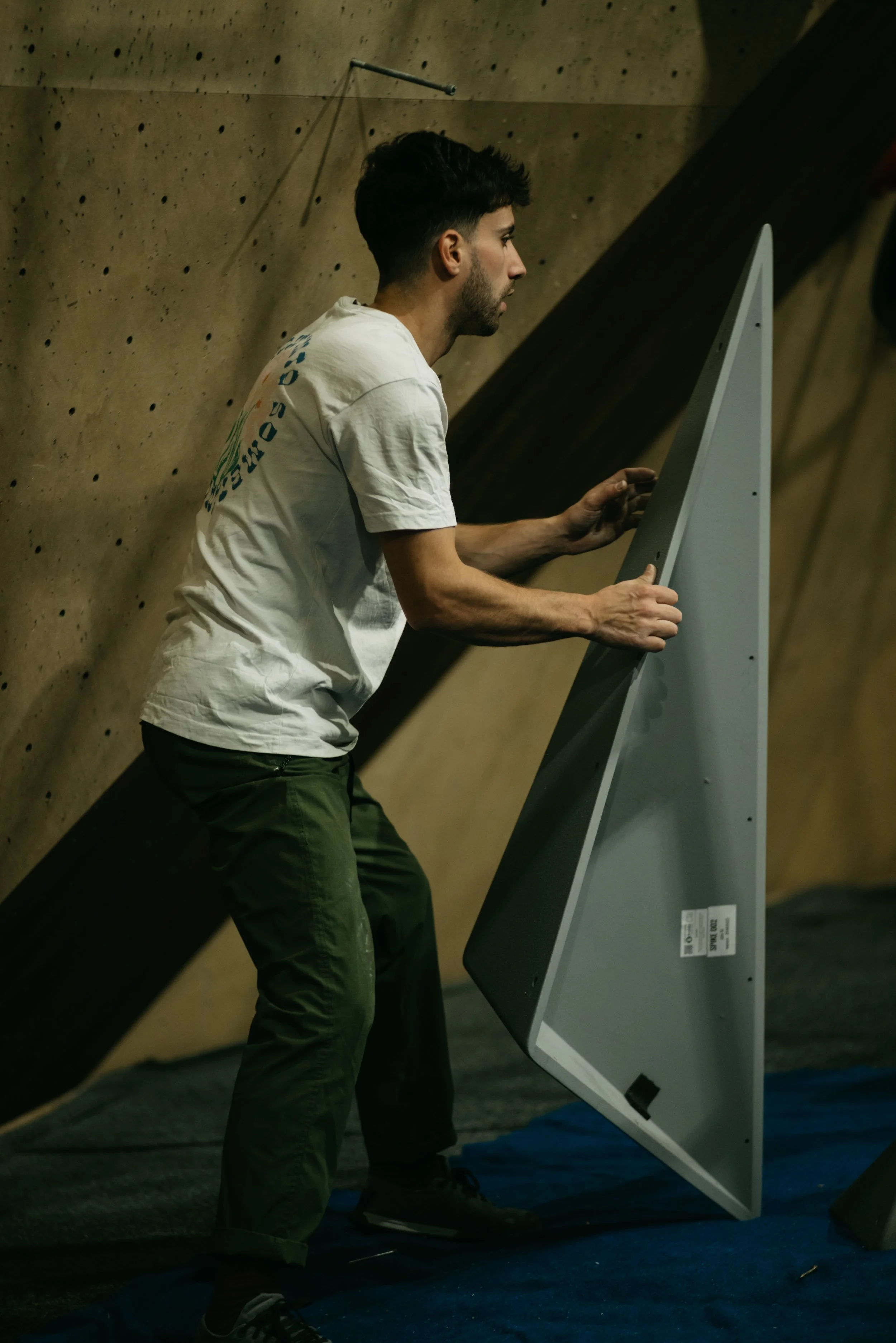 Route setter preparing the finals for Tba 4 at Climbing District Paris on Boldz Holds Double texture Volumes
