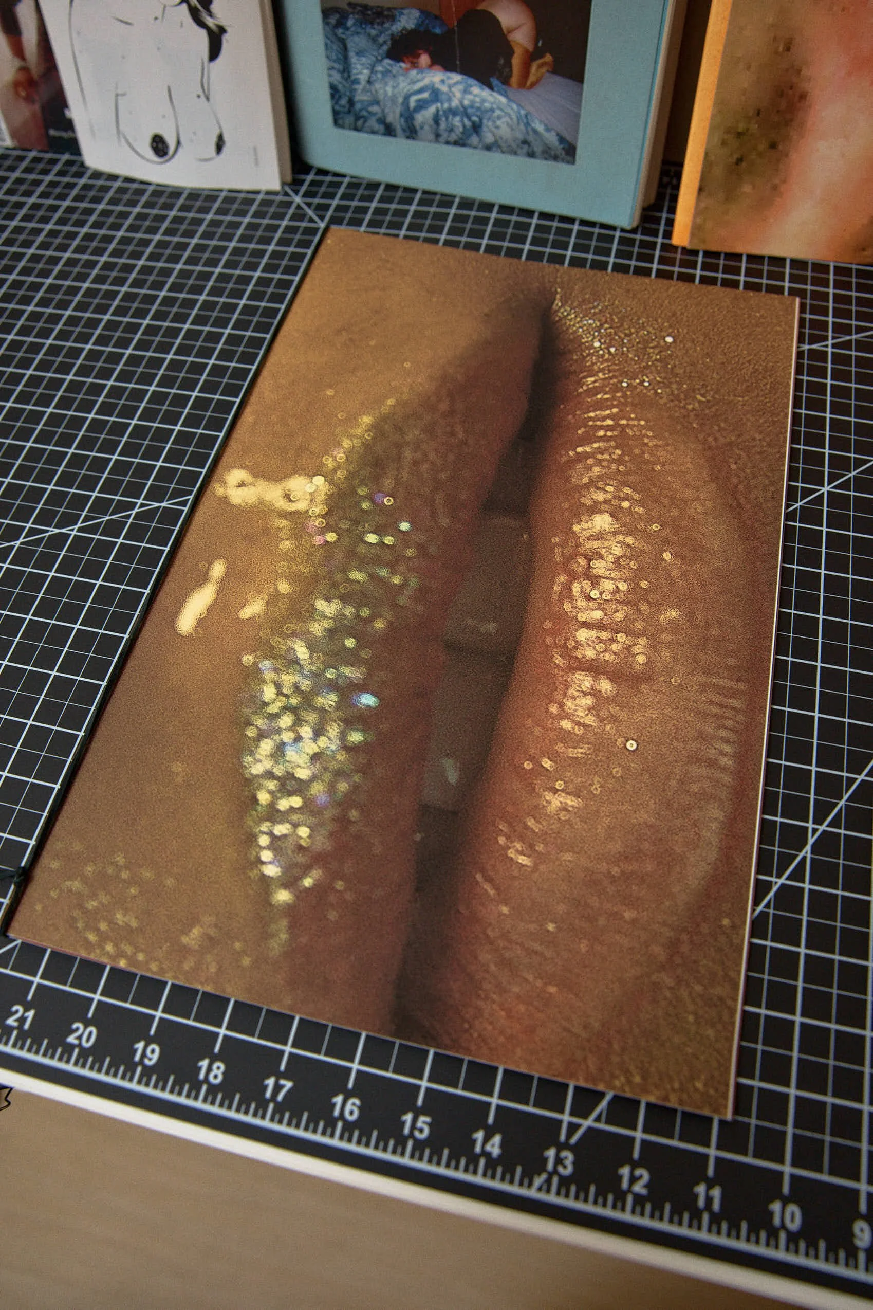 Close-up of a book cover titled "Kiss" featuring a metallic, glittering, close-up image of lips.