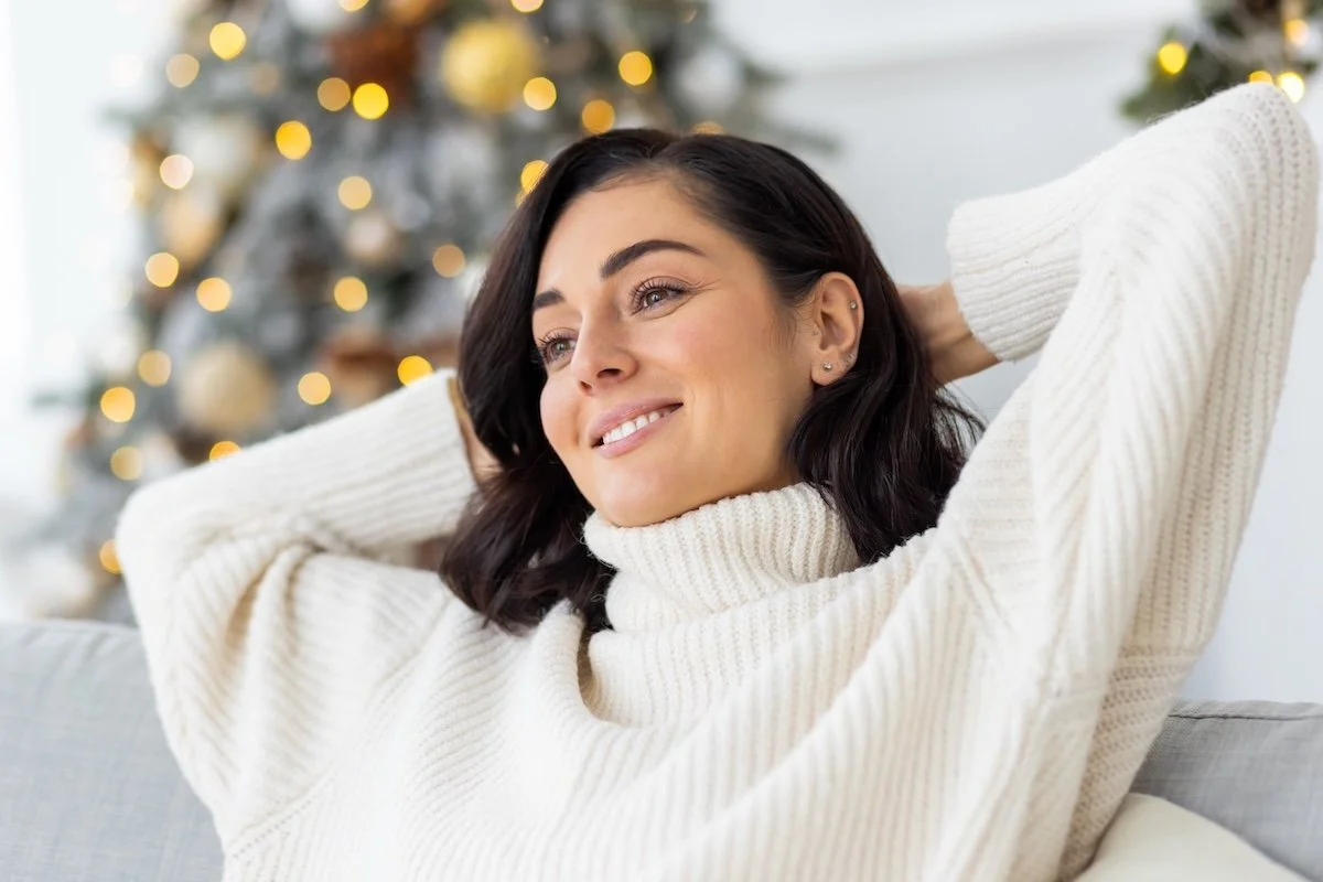 A relaxed woman on the couch at holidays.