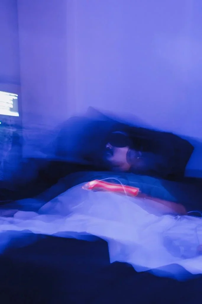 A person laying down with eyemask and headphone on. It appears they are participating in ibogaine therapy for PTSD.