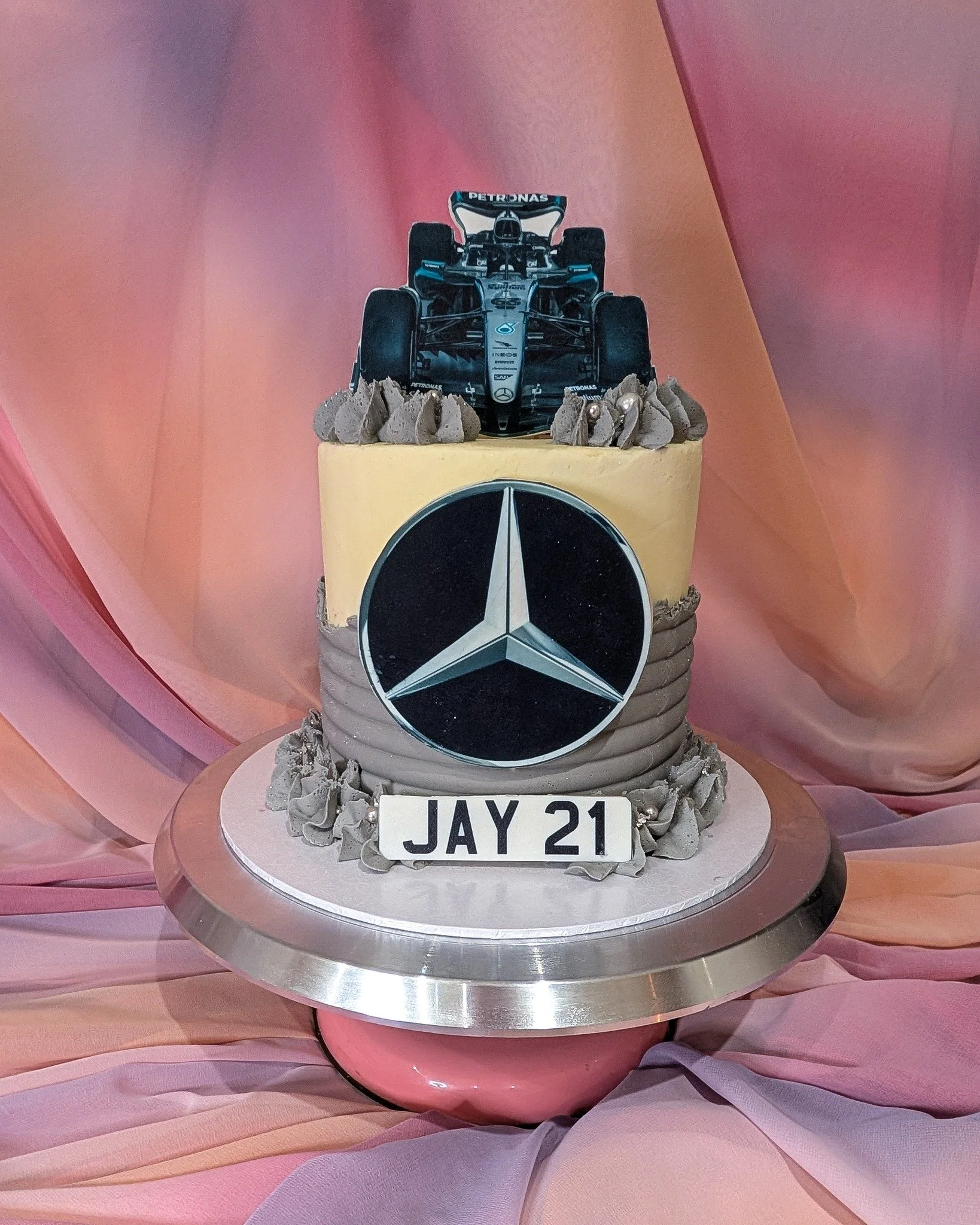 Formula 1 themed cake for Jay&rsquo;s 21st birthday, with a Mercedes logo and F1 car topper.
Chocolate sponge inside, with the design built around what he&rsquo;s into.

If you&rsquo;re planning a milestone birthday and want something personal to the