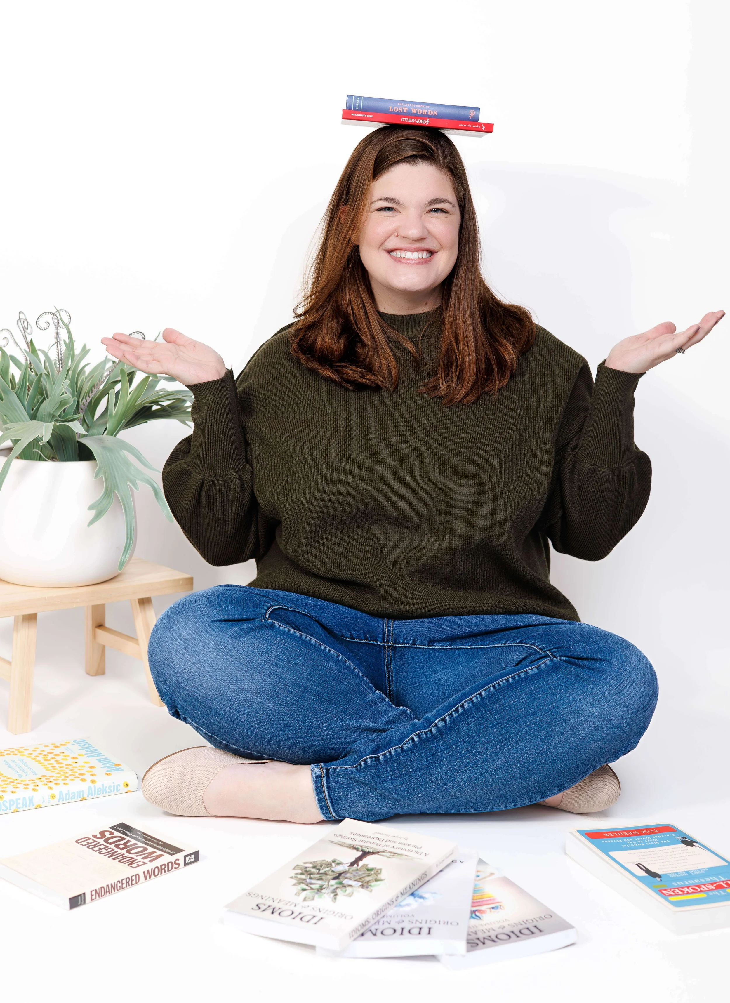 Blog copywriter Sarah Taveras balancing books on her head.