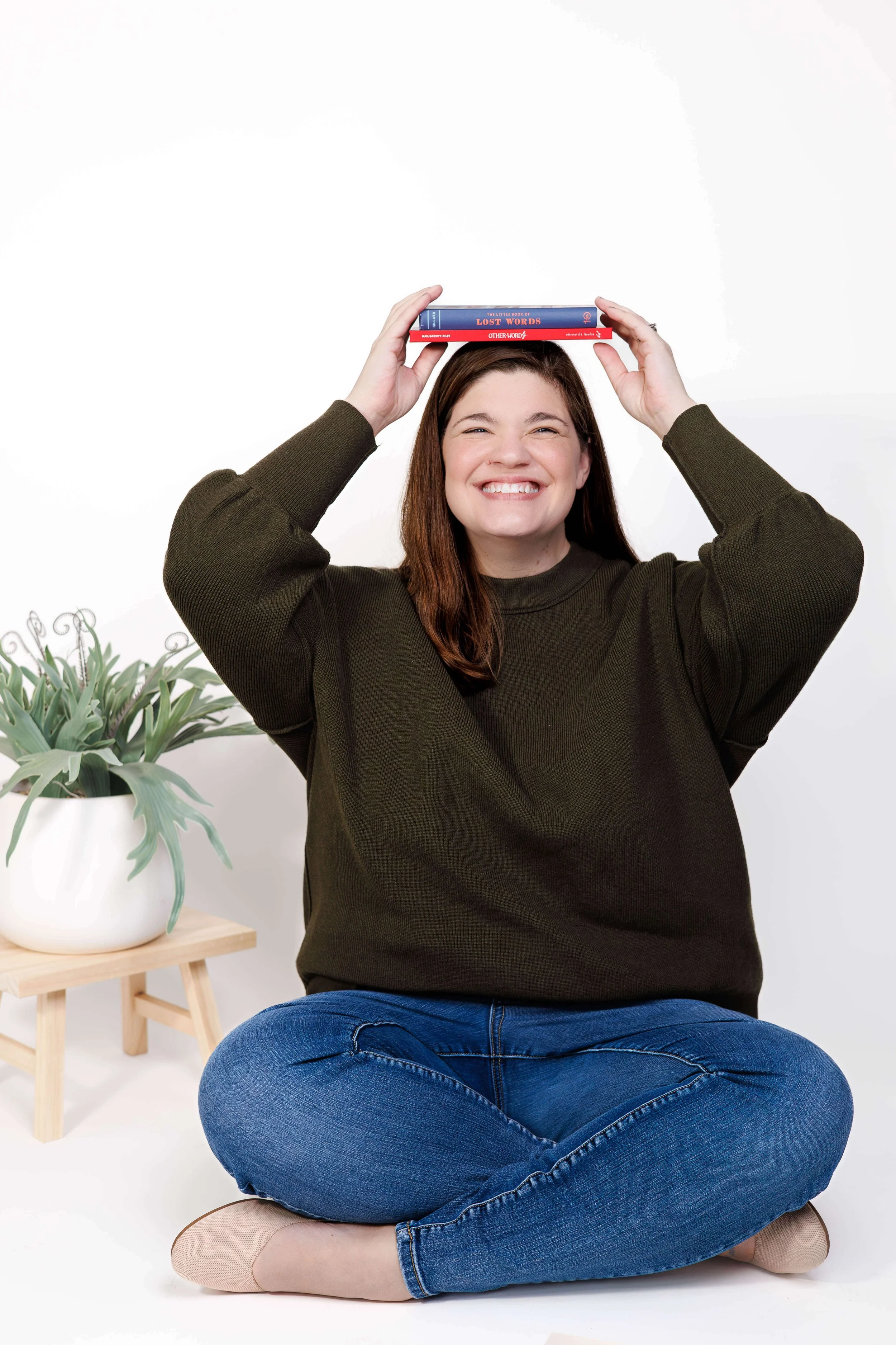 Blog copywriter Sarah Taveras placing books on her head to balance.