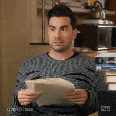 David from Schitt's Creek looking awkward reading a script.