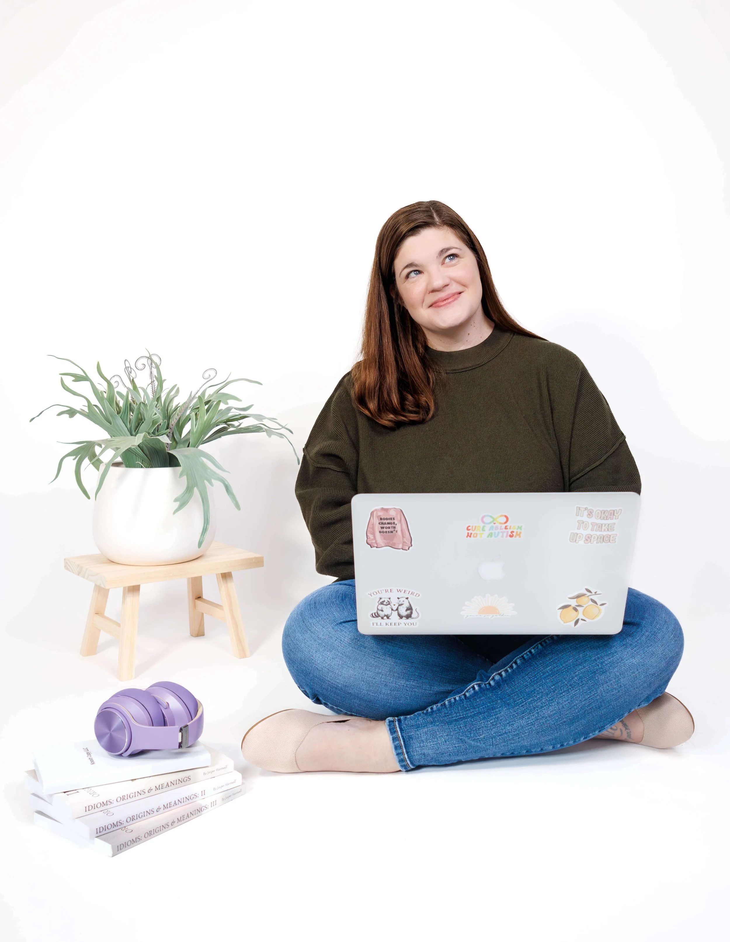 Sarah with her laptop open, gazing off in thought.