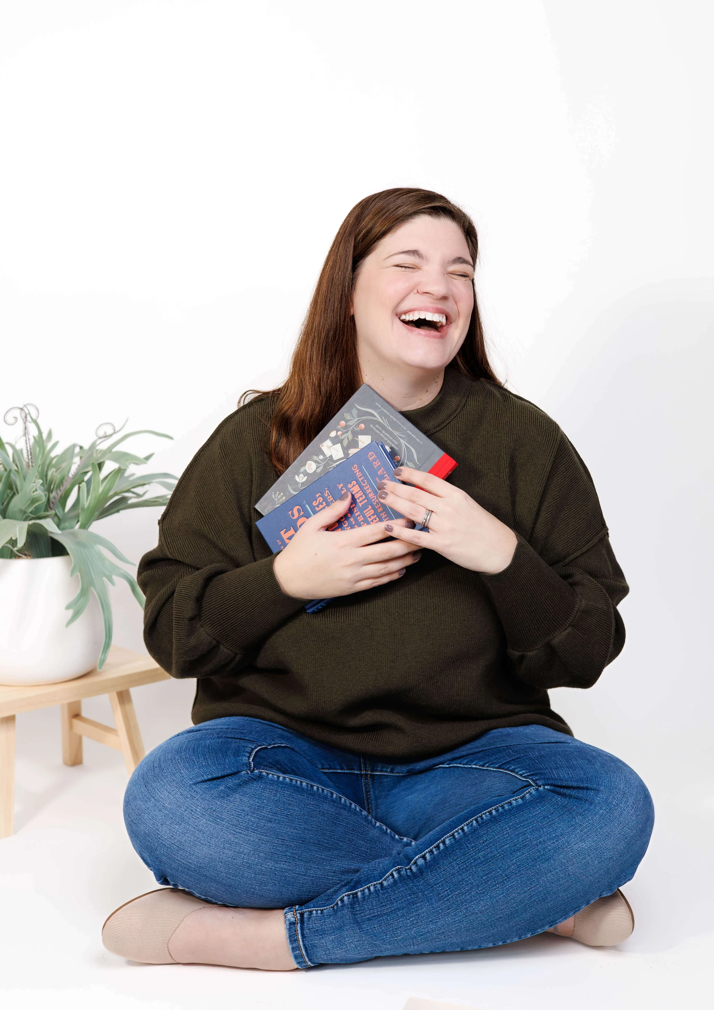 Blog copywriter Sarah Taveras catching books falling off her head.