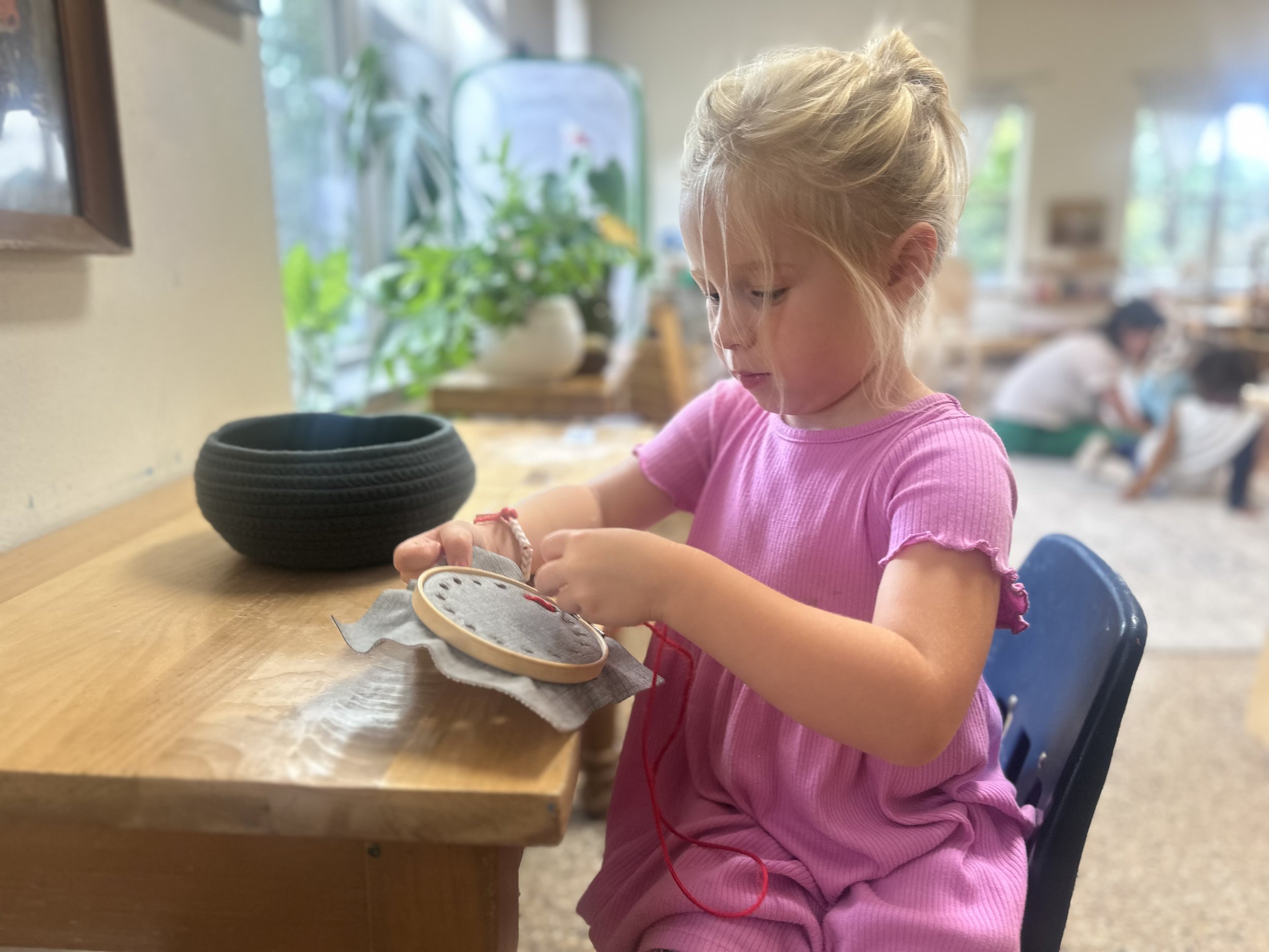 Girl in classroom sewing