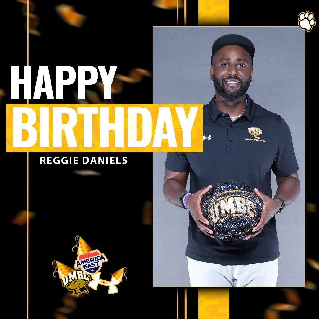 Modern house with wooden exterior, large glass window, set against a mountainous landscape with grassy terrain in the foreground.