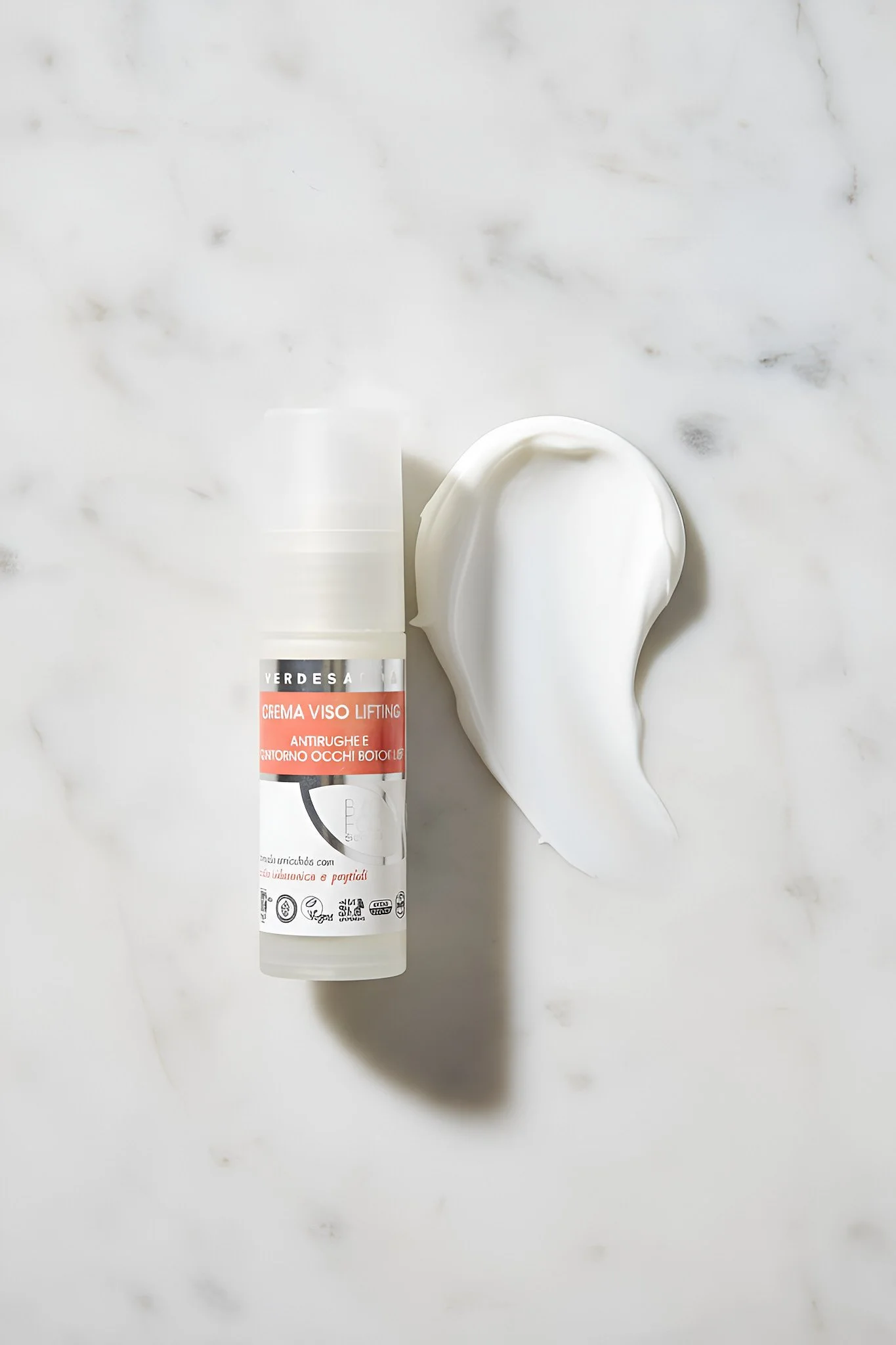 Skincare product collection on marble background with minimalist aesthetic, showcasing multiple cosmetic bottles in luxury editorial composition