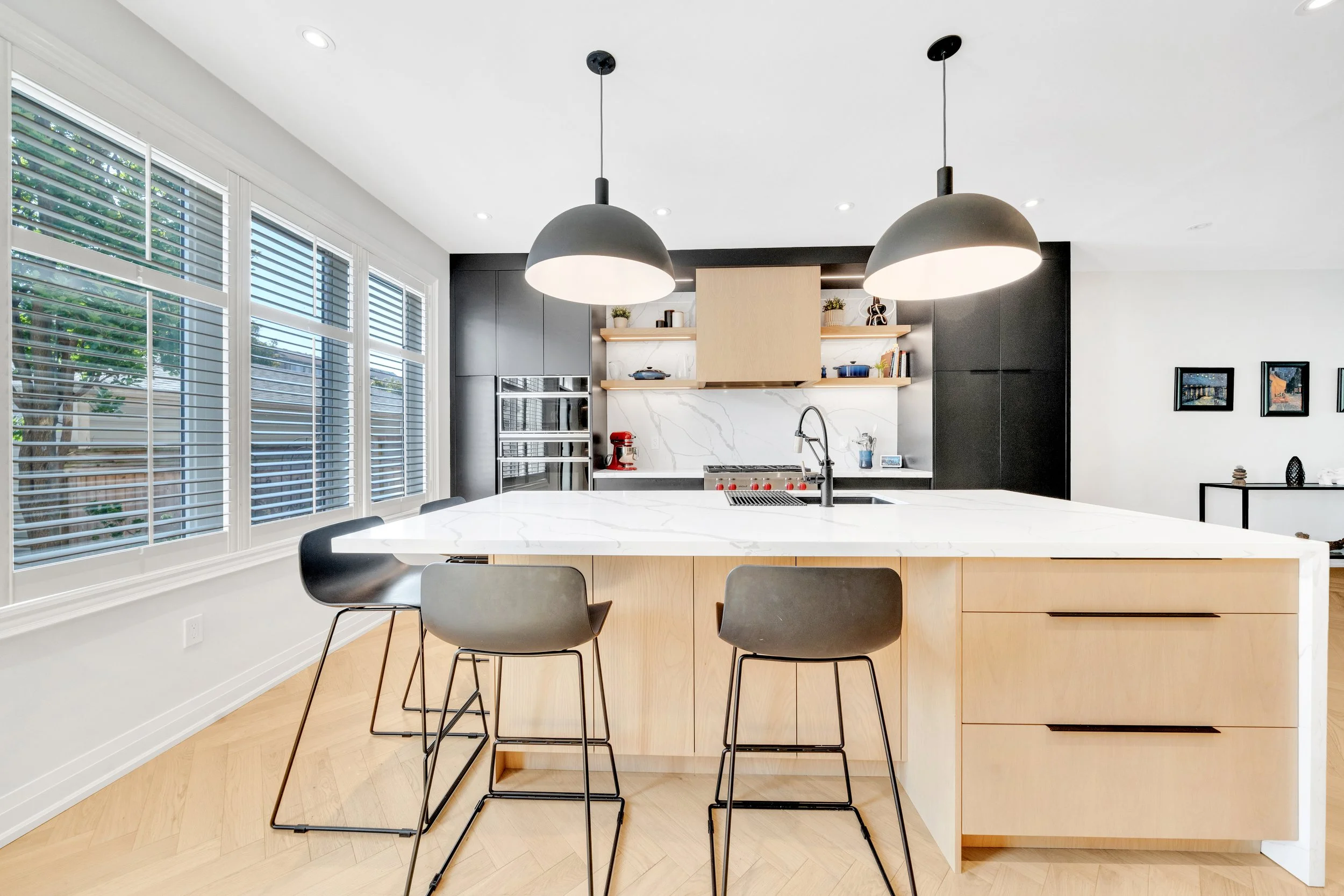 Modern kitchen interior with island, pendant lights, and bar stools