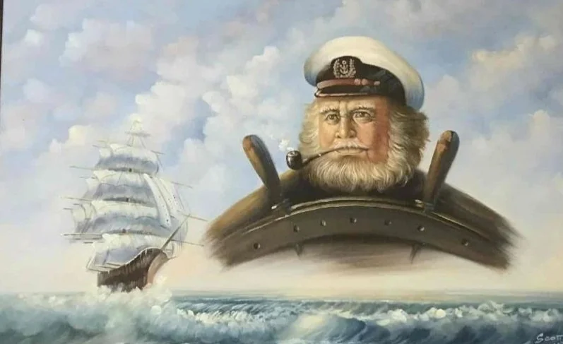 A cartoonish drawing of an old captain with a beard, wearing a white captain's hat with an anchor emblem, sitting in a ship's wheelhouse, with a large sailing ship in the background on the ocean.