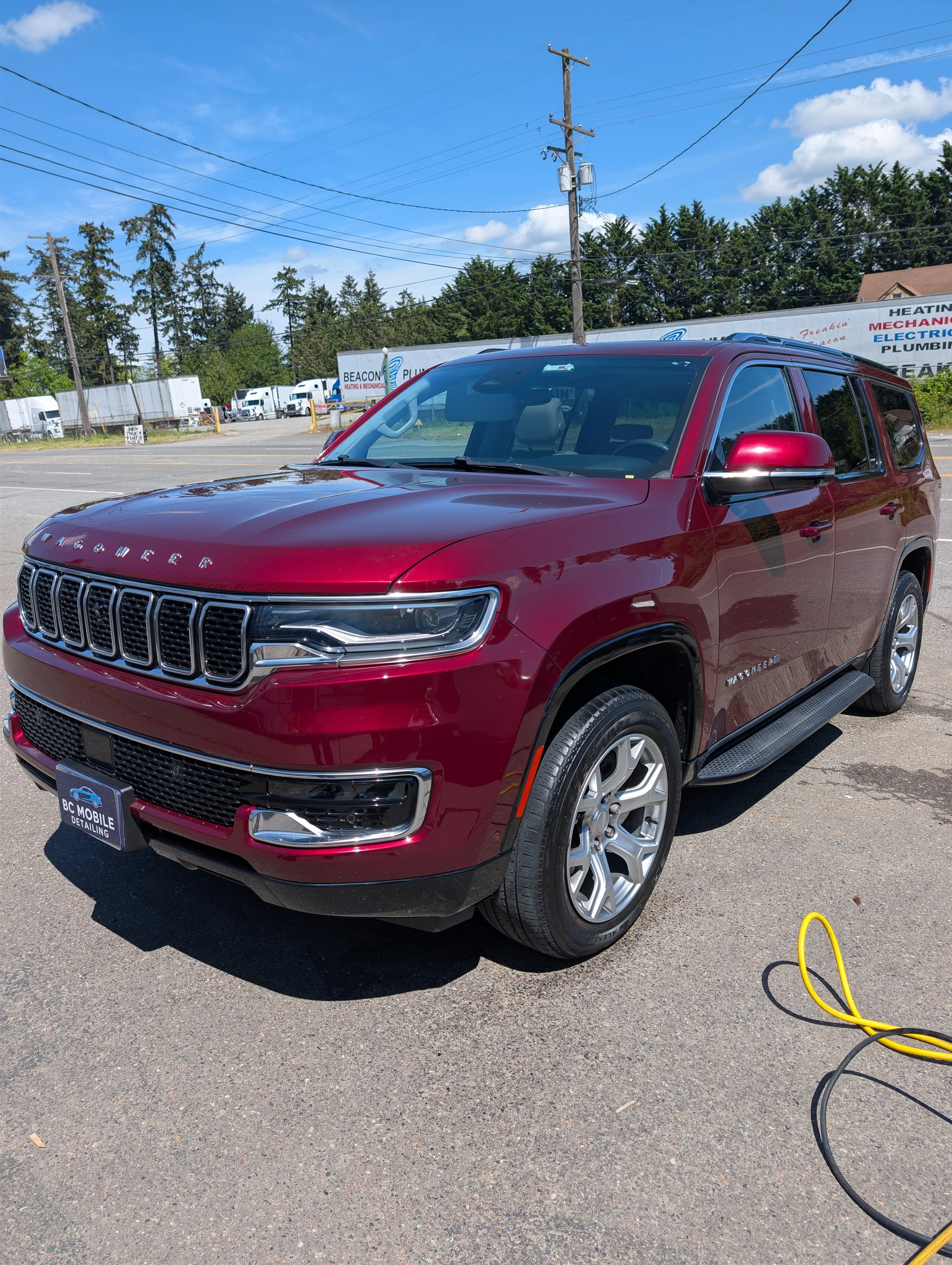 Red SUV Jeep Wagoneer after a Full Detail with Wax/Sealant showing the deep shine.
